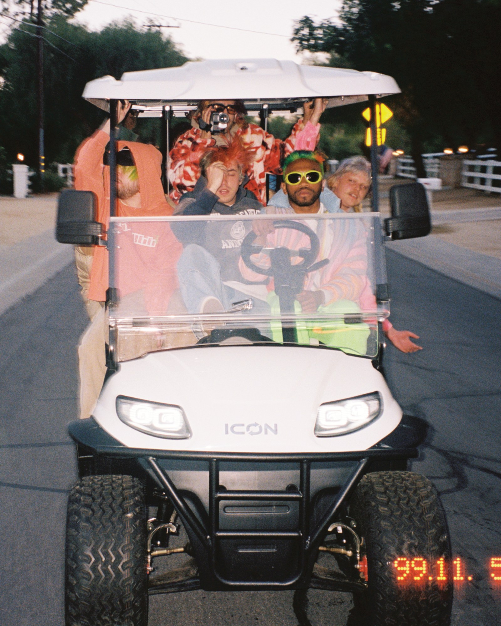 Brockhampton all crammed onto a golf cart, with Kevin Abstract driving