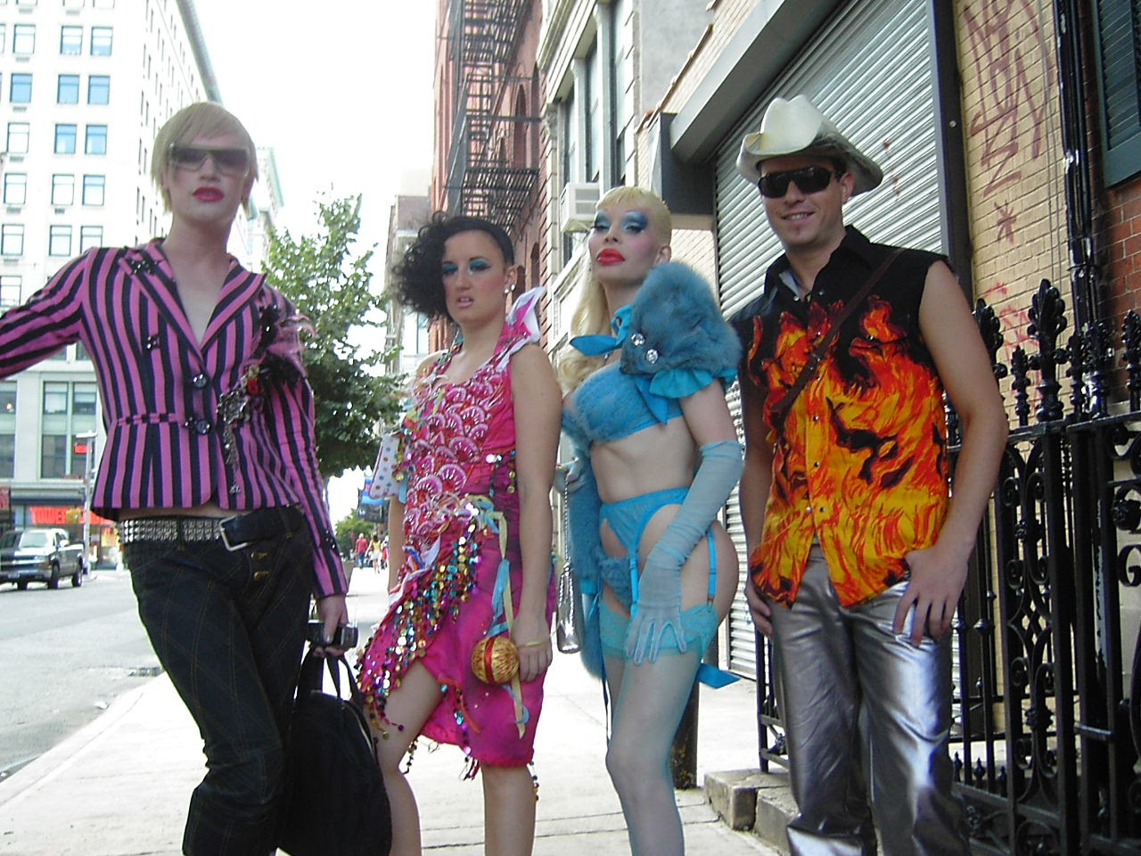 Richie Rich, Aimee Phillips, Amanda Lepore, Traver Rains stood on a street in New York's East Village wearing bright, garish clothes by Heatherette