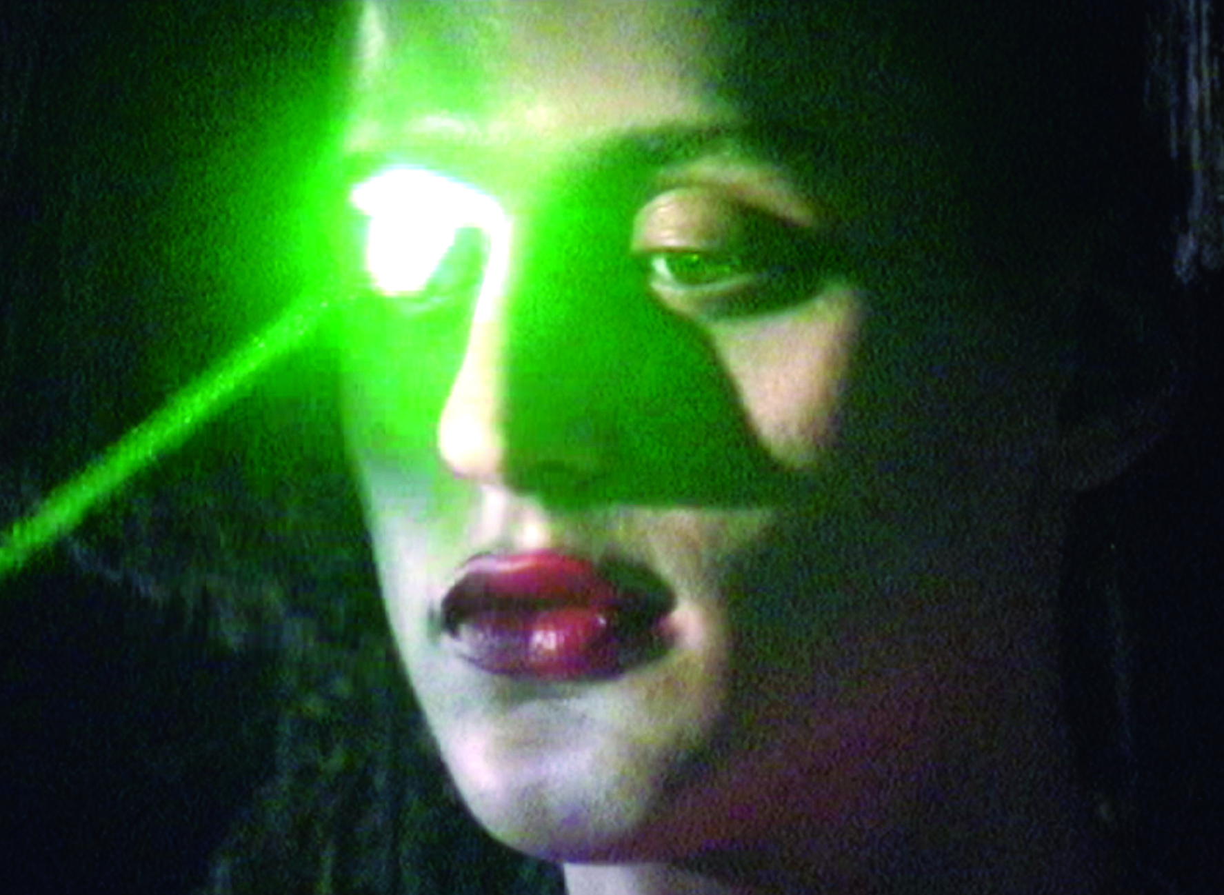 the musician arca with green light shining onto them