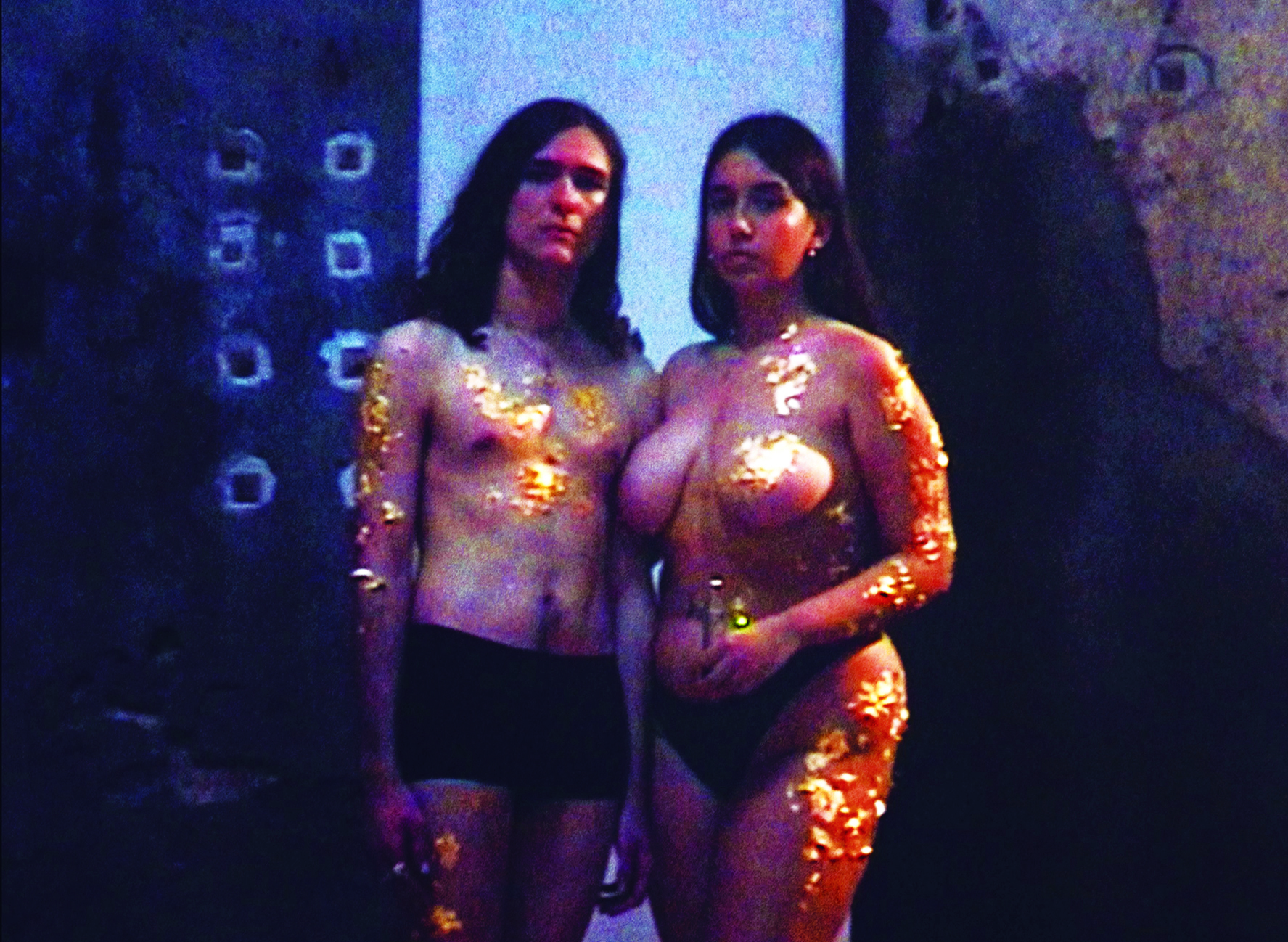 two people wearing underwear and nothing on top covered in glitter