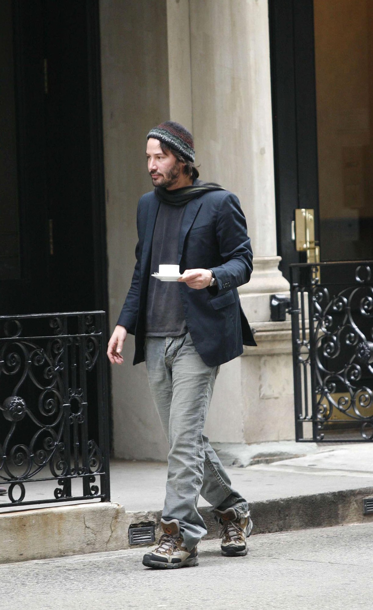 keanu reeves walking in new york city with a teacup in his hand