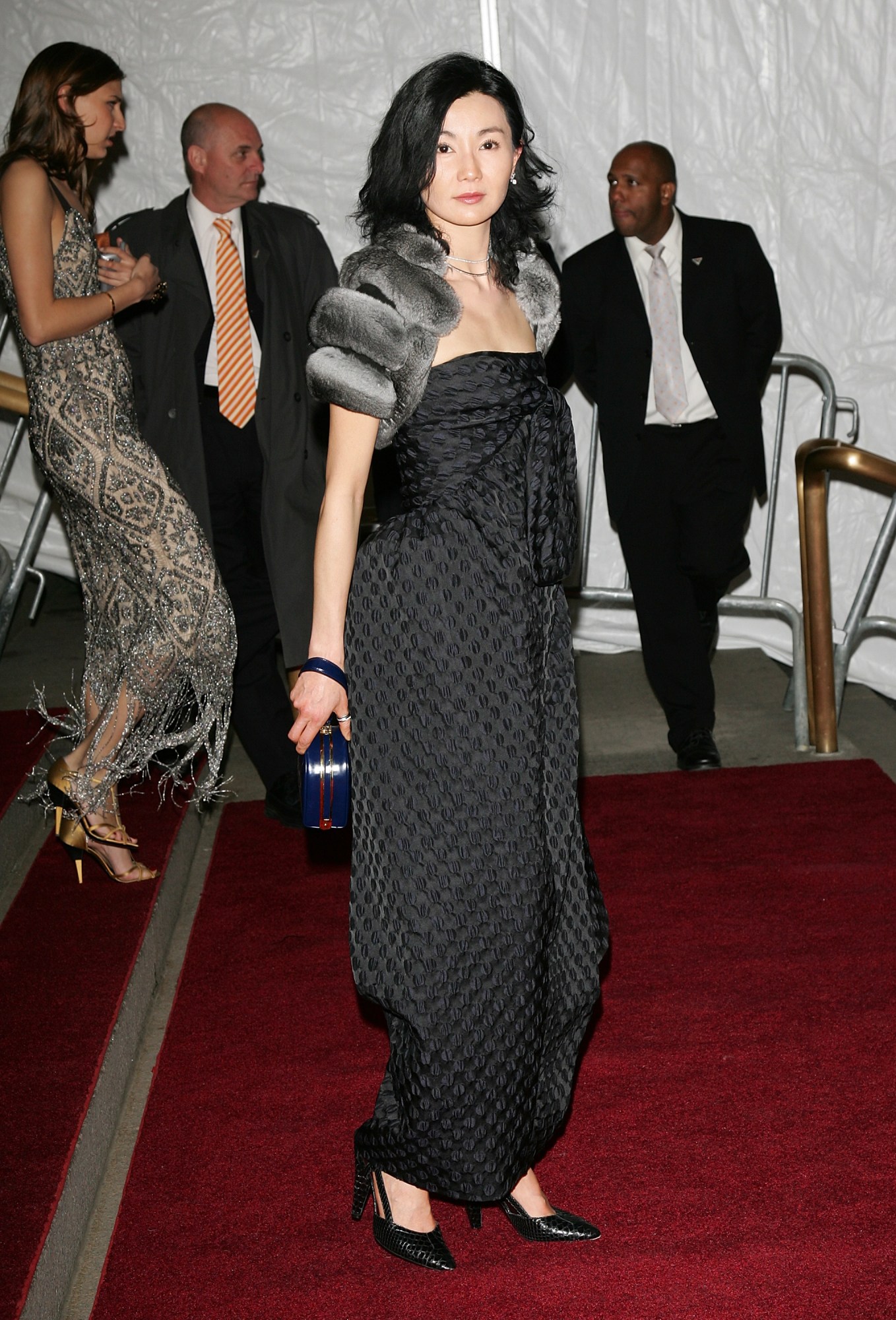 maggie cheung poses on the red carpet at the met gala