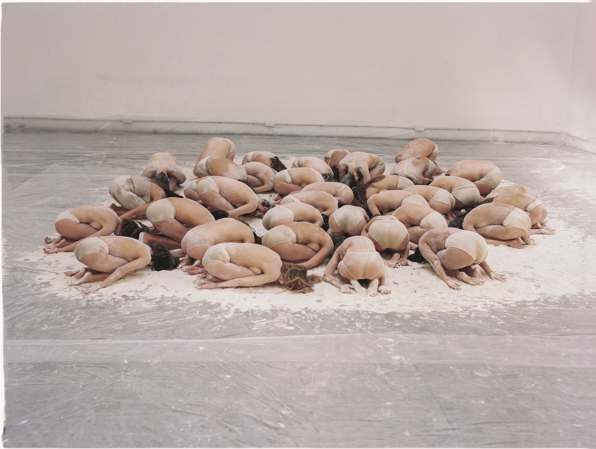 a group of women lying face down on the floor photographed by carlota guerrero