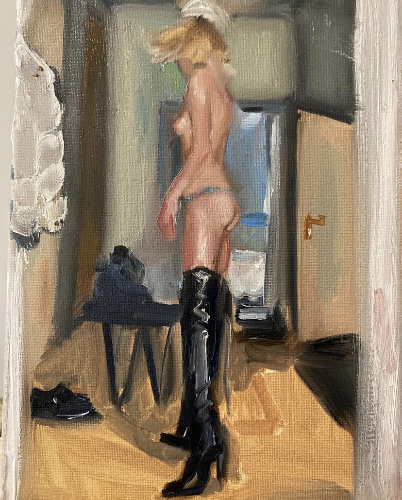 a nude woman wearing thigh high black leather boots looks away