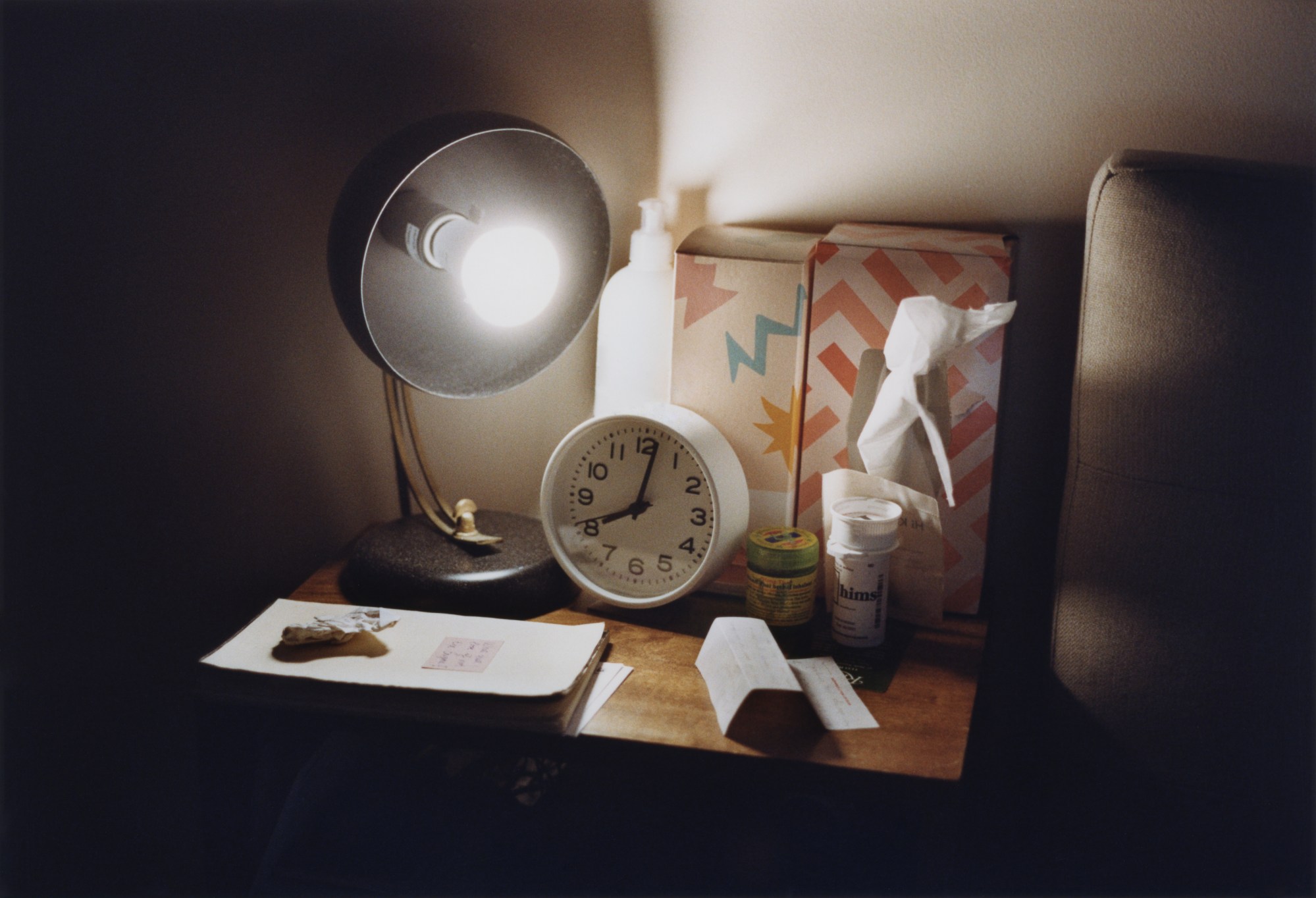 Bedside table with a lamp turned on