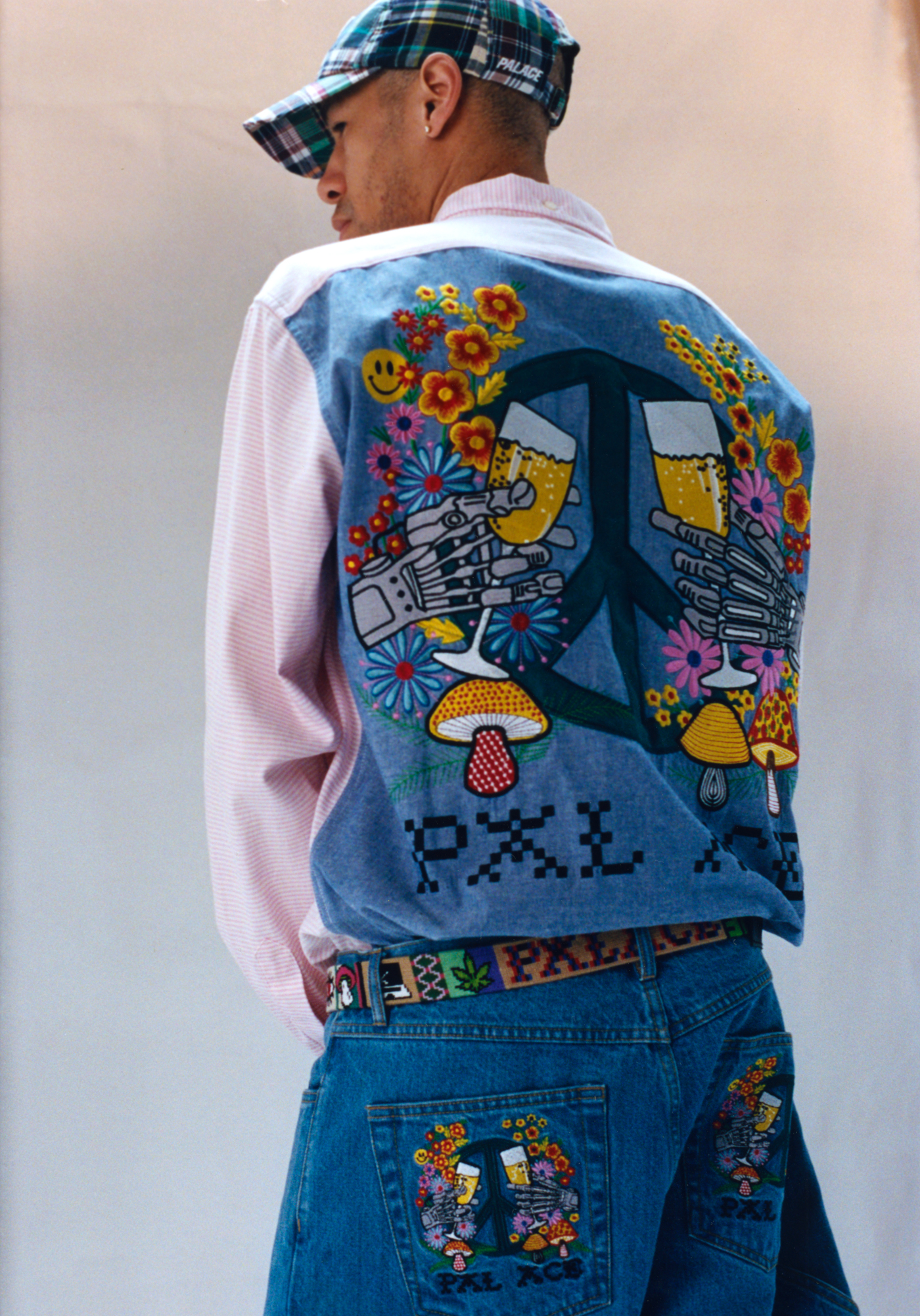 Skater and model Lucien Clarke wearing matching shirt and blue denim embroidered with trippy Americana motifs