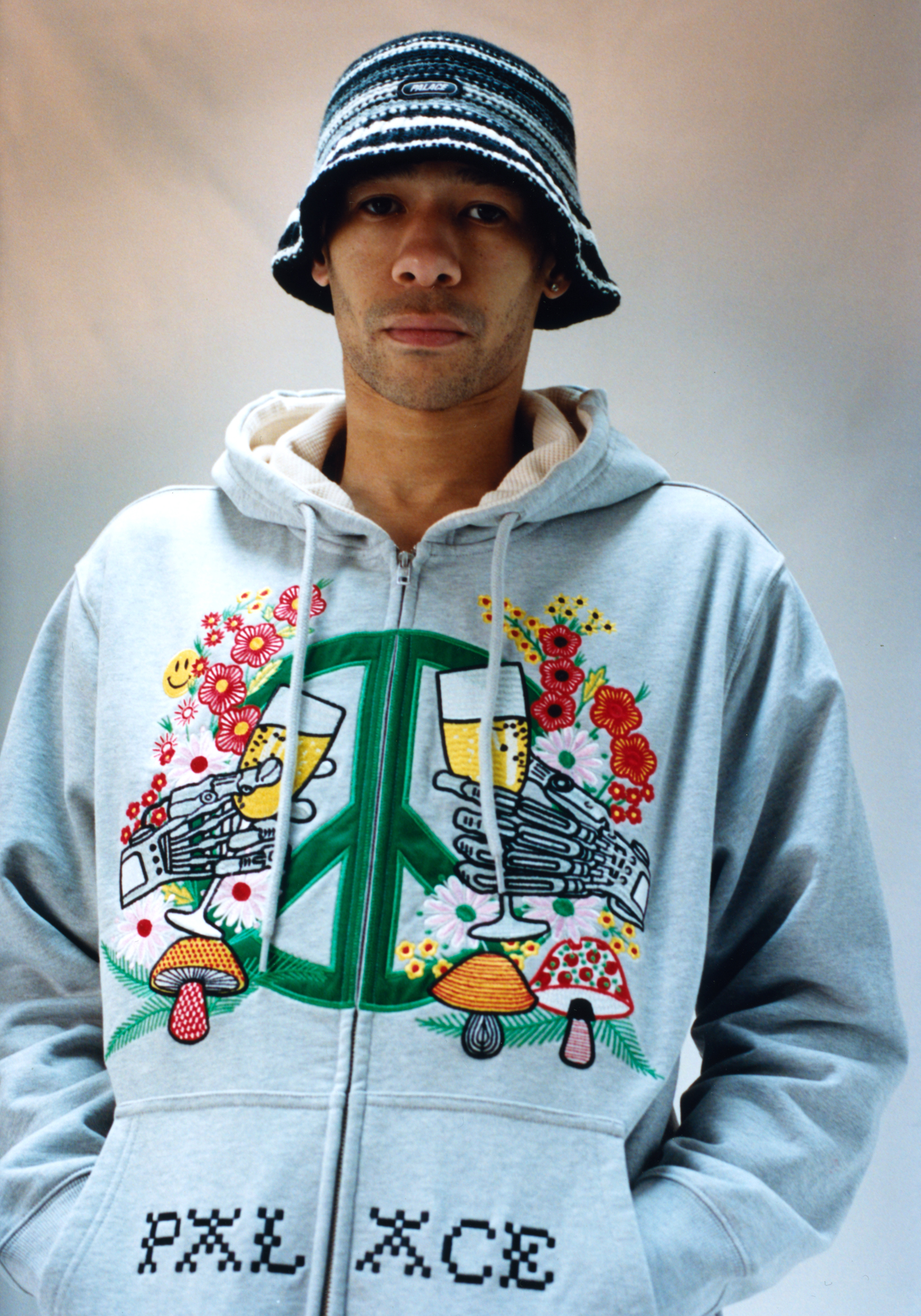 Skater and model Lucien Clarke wearing embroidered Palace hoodie with trippy Americana motifs and a bucket hat