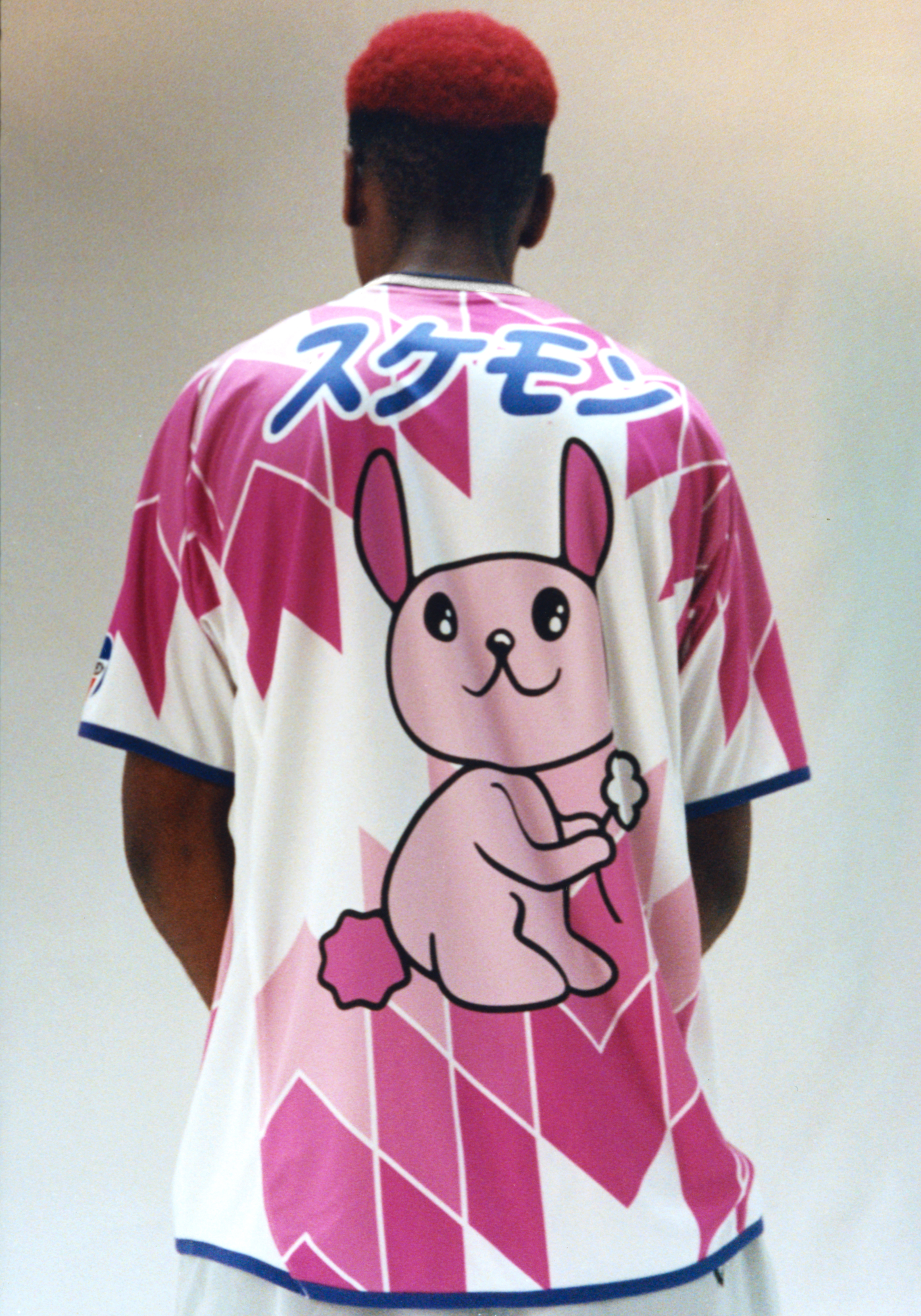 Skater and model Kyle Wilson wears a football top from Palace with a pink kawaii bunny print on the back