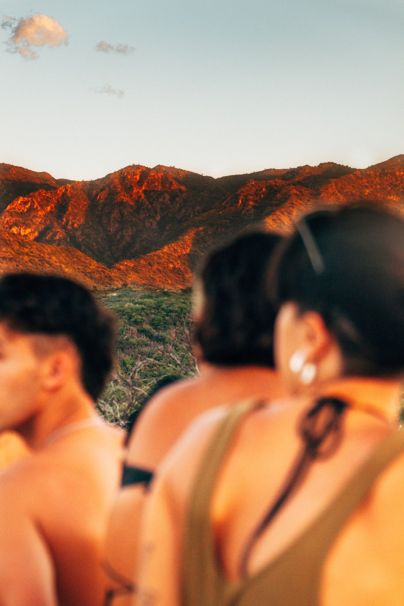 blurred figures in the foreground with a sunset backdrop of mountains in argentina