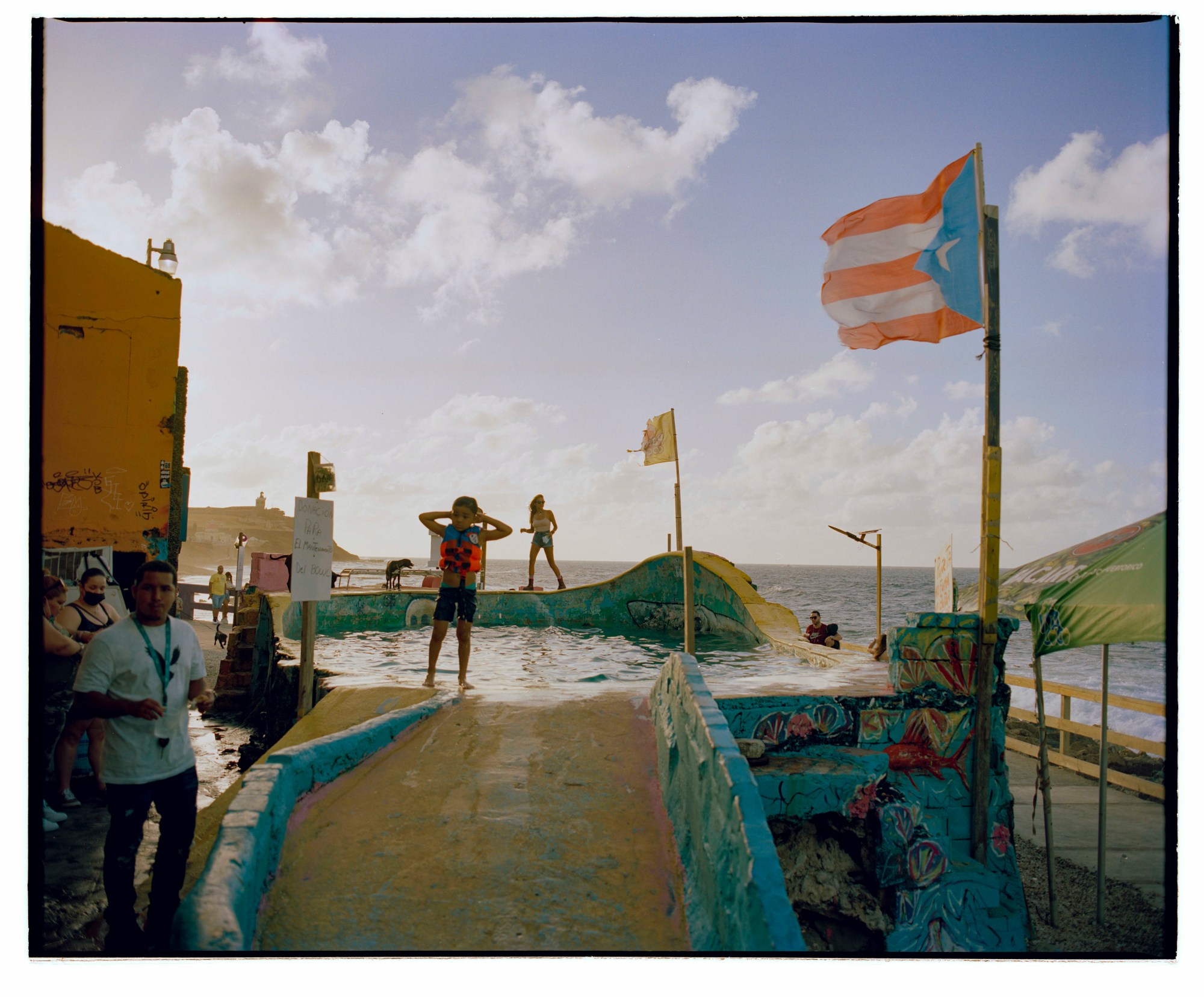 children playing in a colourful water playground by the sea