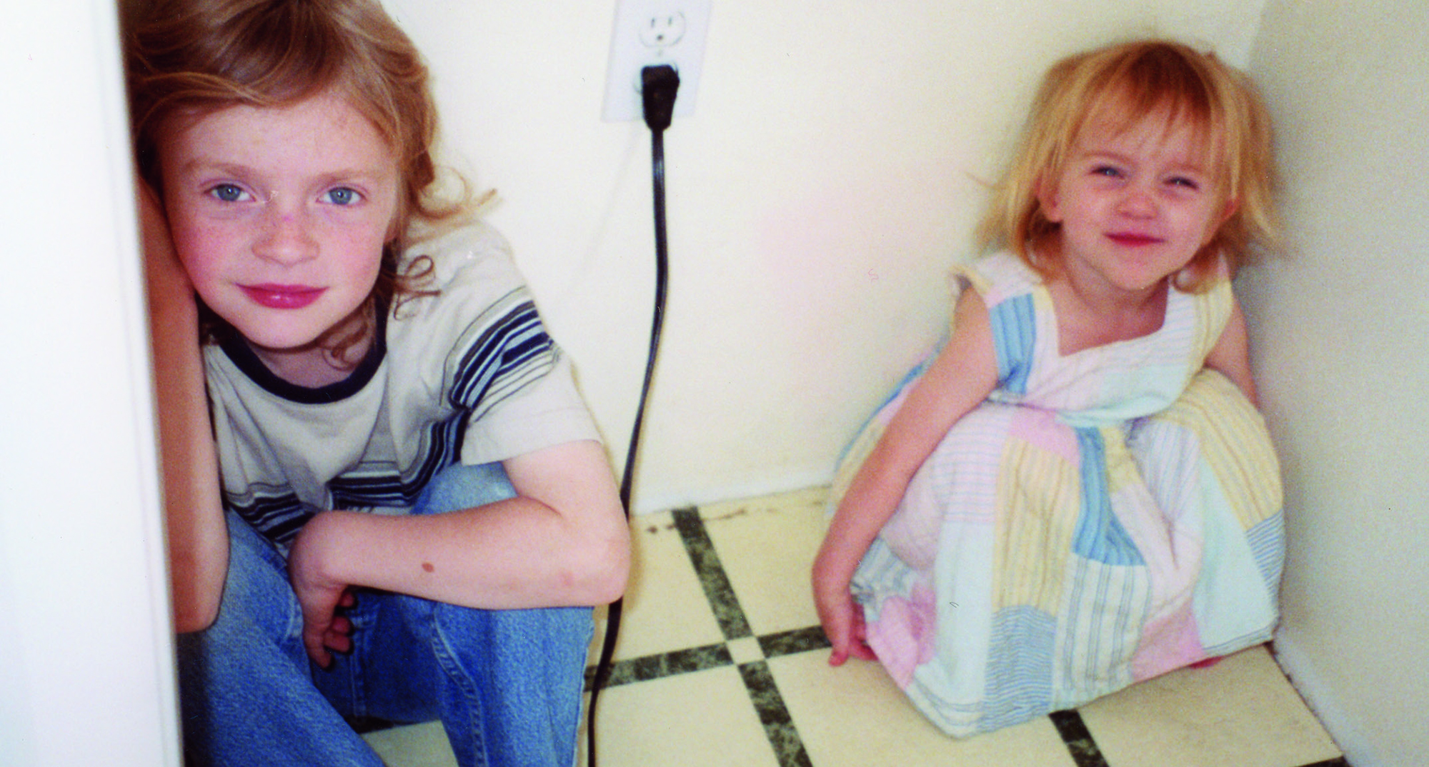 billie eilish and her brother finneas as kids crouching on a kitchen floor