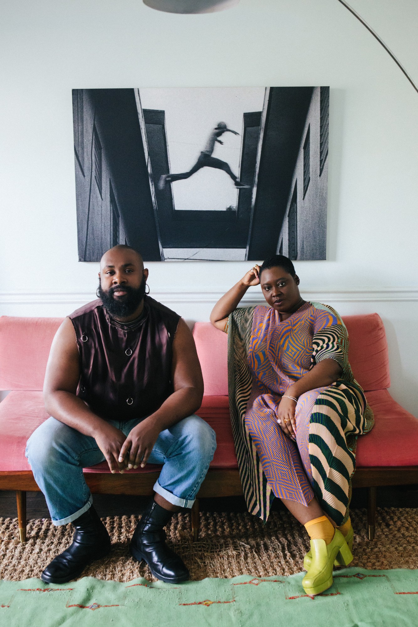 Zeba Blay and Keesean Moore sitting on a pink couch