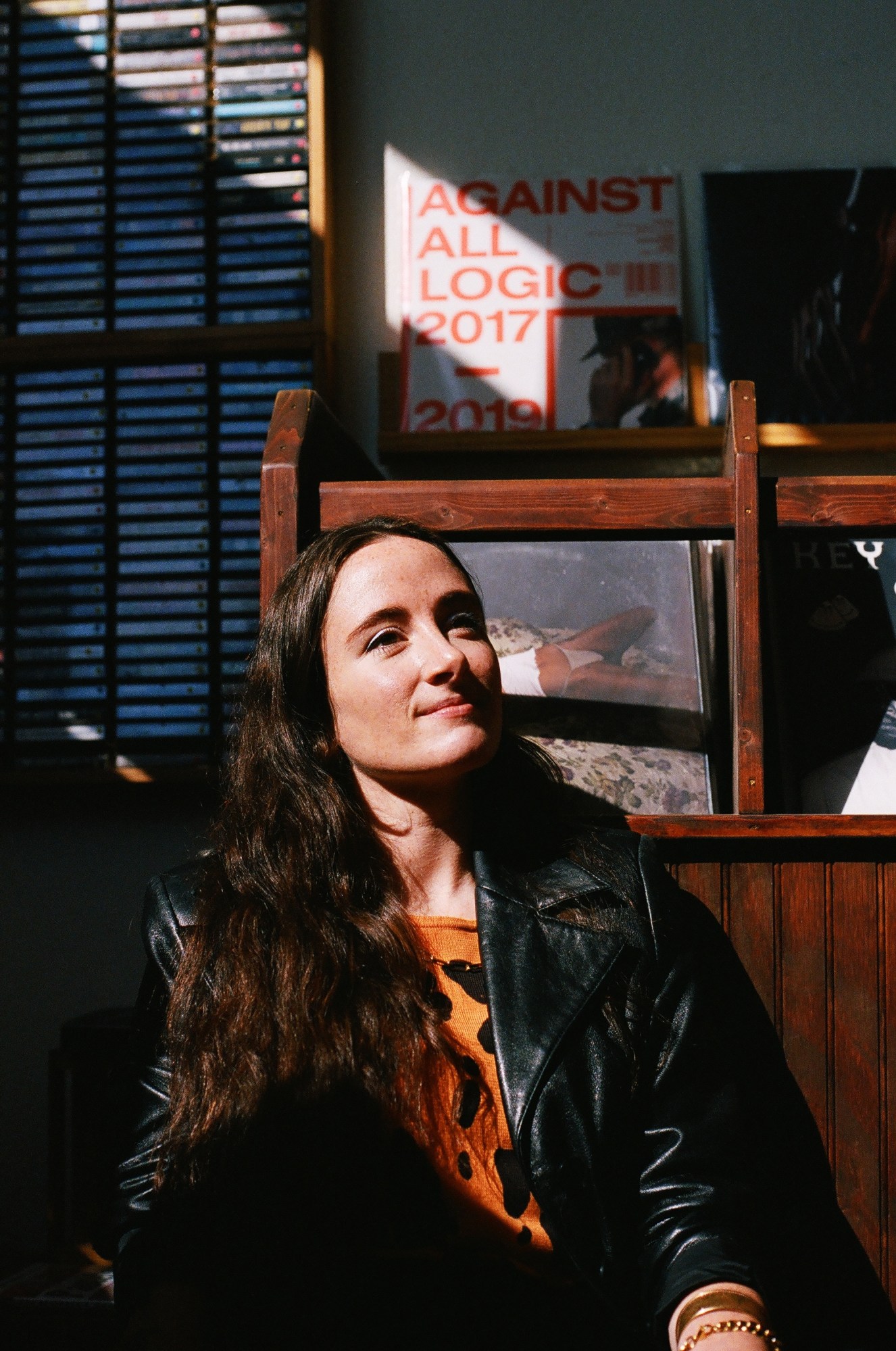 annelise kopp inside a record store looking up into the sunlight