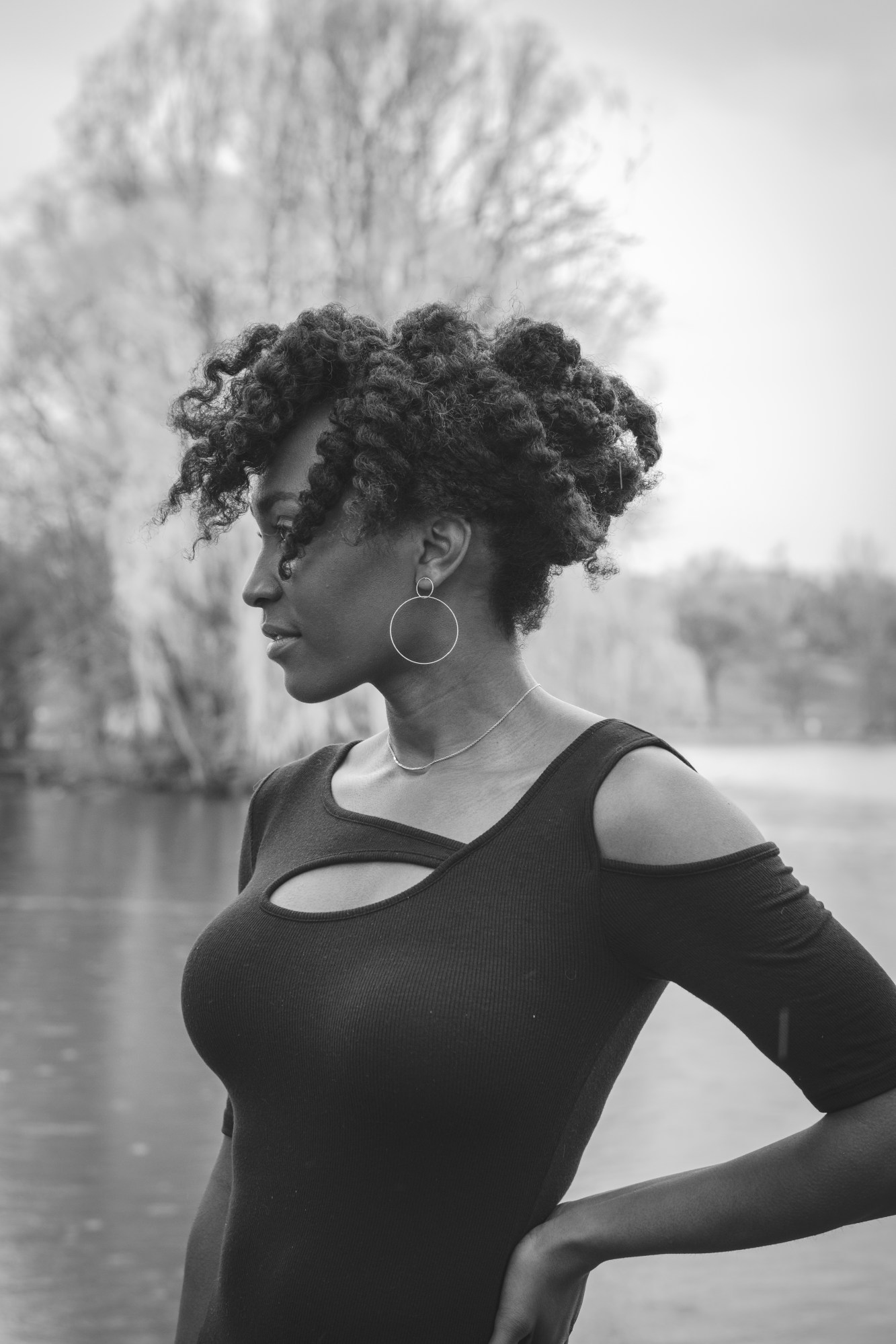 Arielle Grant standing in front of a lake with trees.