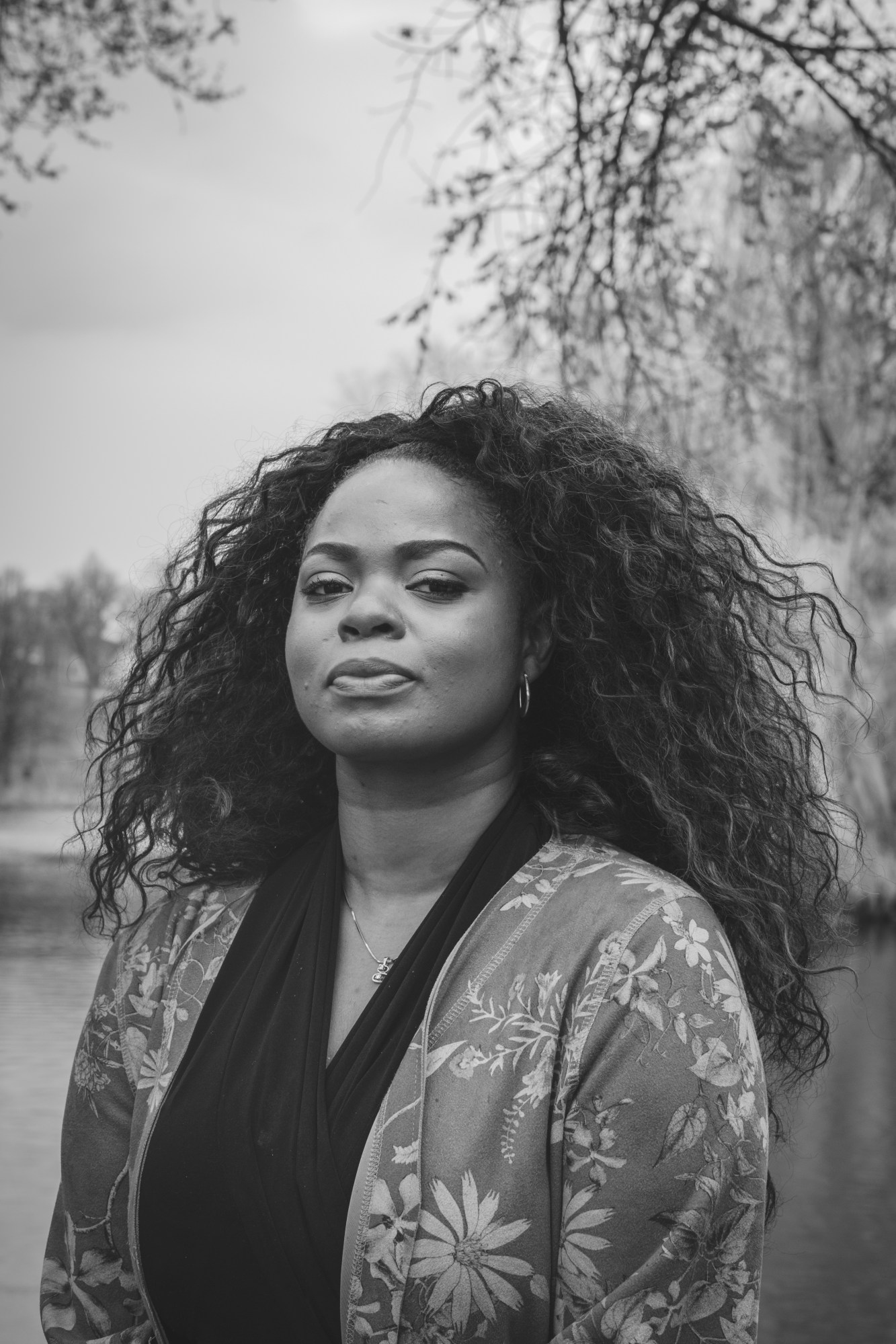 Lissa Karpeh standing in front of a lake with trees.