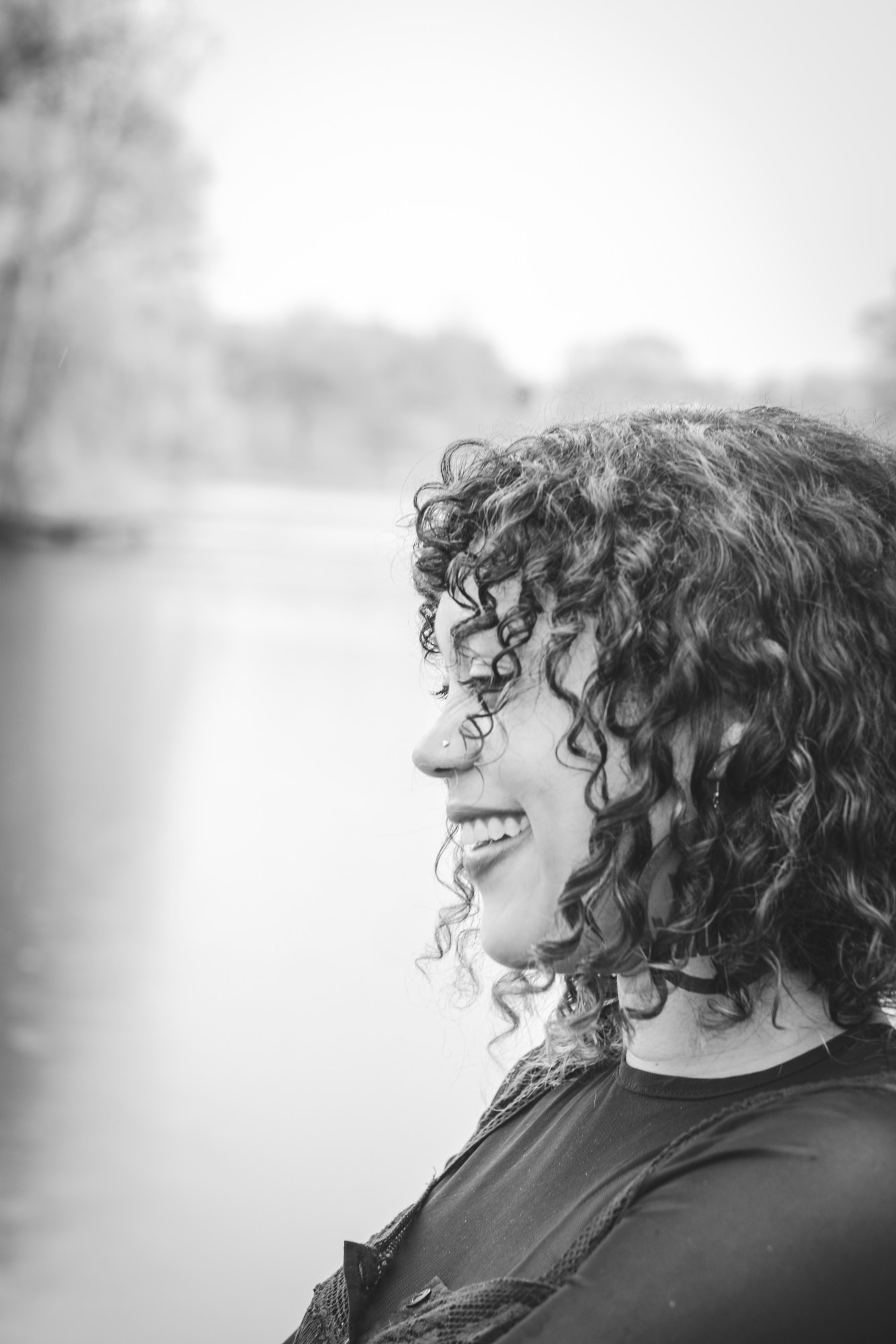 Leslie Barlow standing in front of a lake with trees.