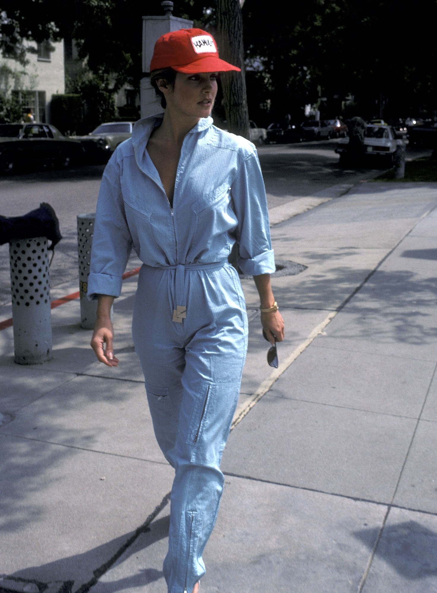 priscilla presley walking down the street in a blue jumpsuit