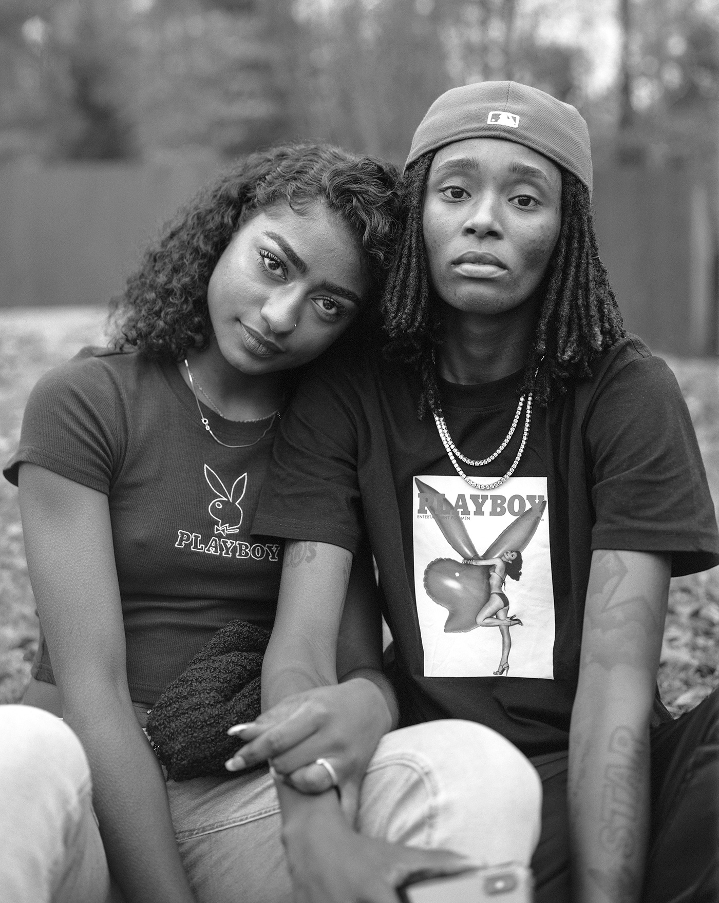 two women wearing playboy t-shirts link arms