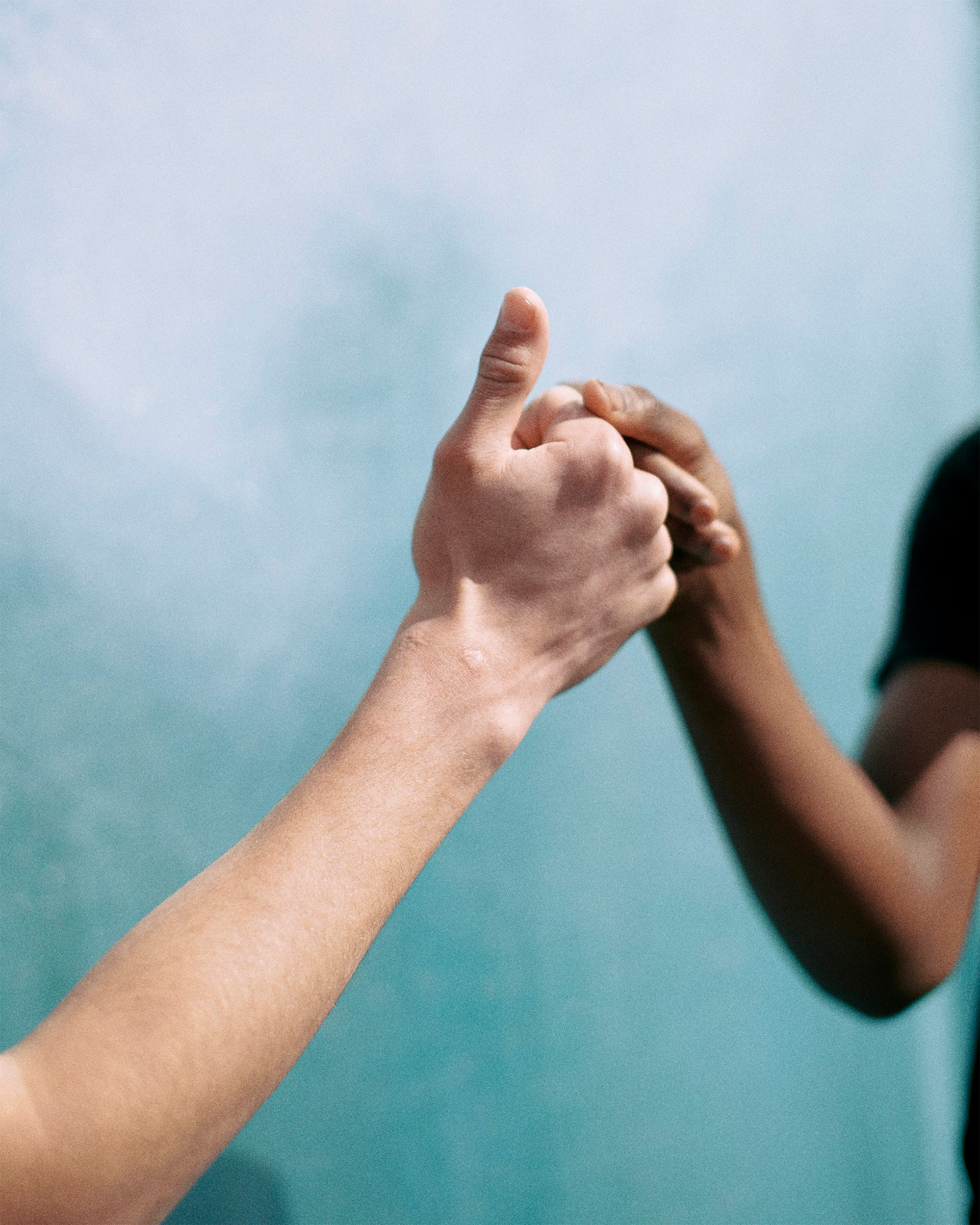 Two fists bumping on a blue background