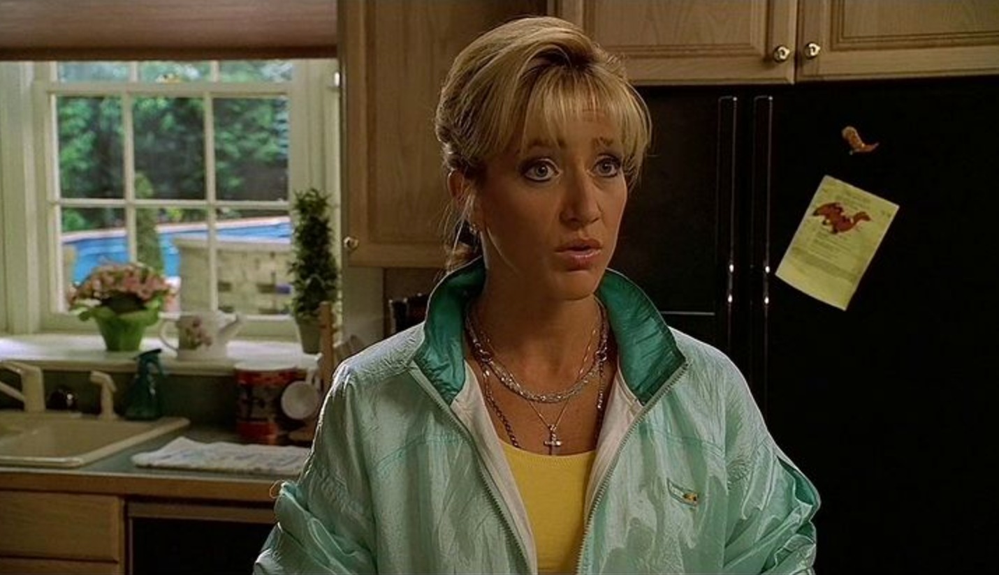 carmela soprano standing in her kitchen wearing a tracksuit top and jewellery