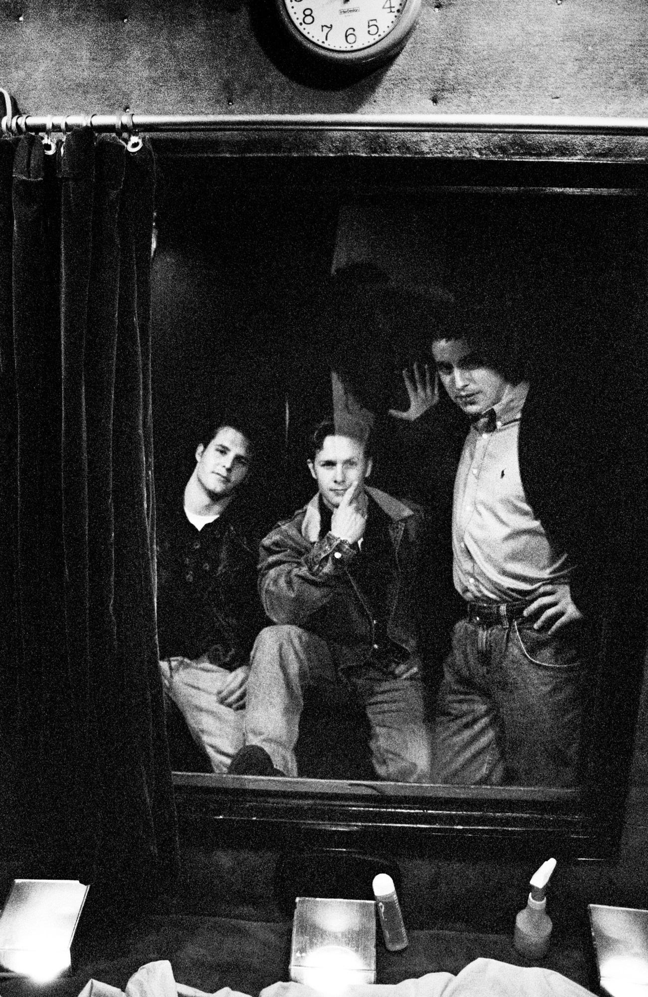 three men inside a pleasure booth at a strip club