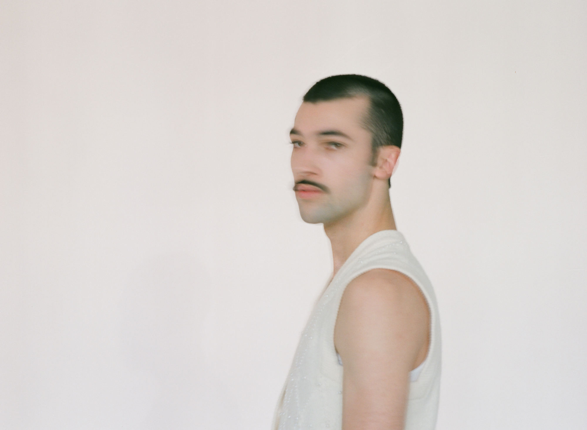 a blurred portrait of leo reilly from the side