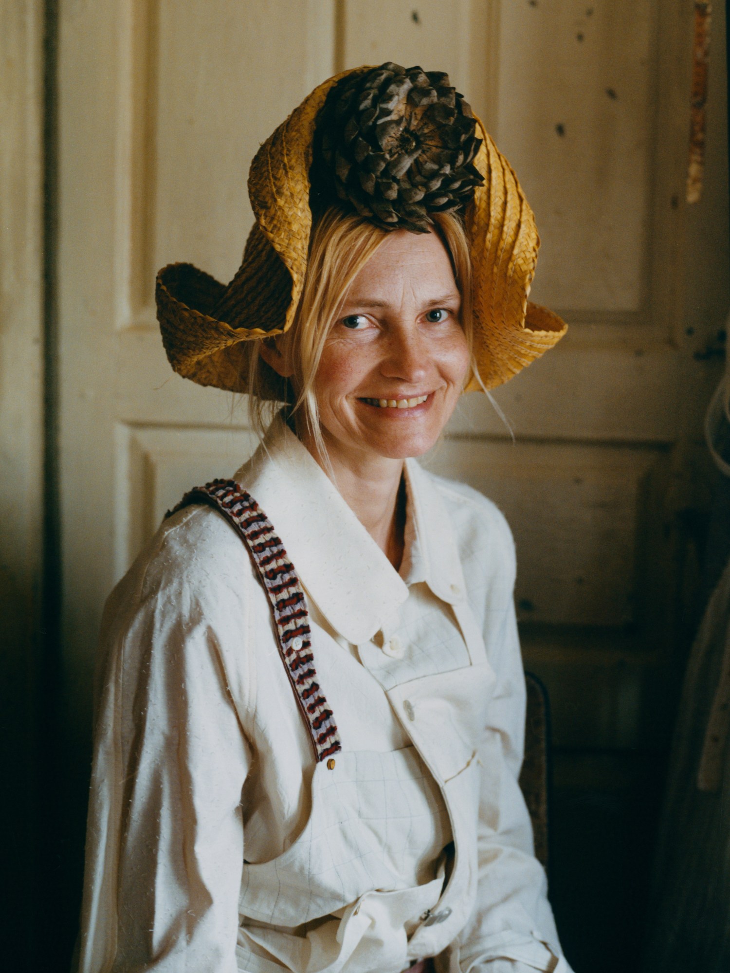 a woman with a large pine cone on her head