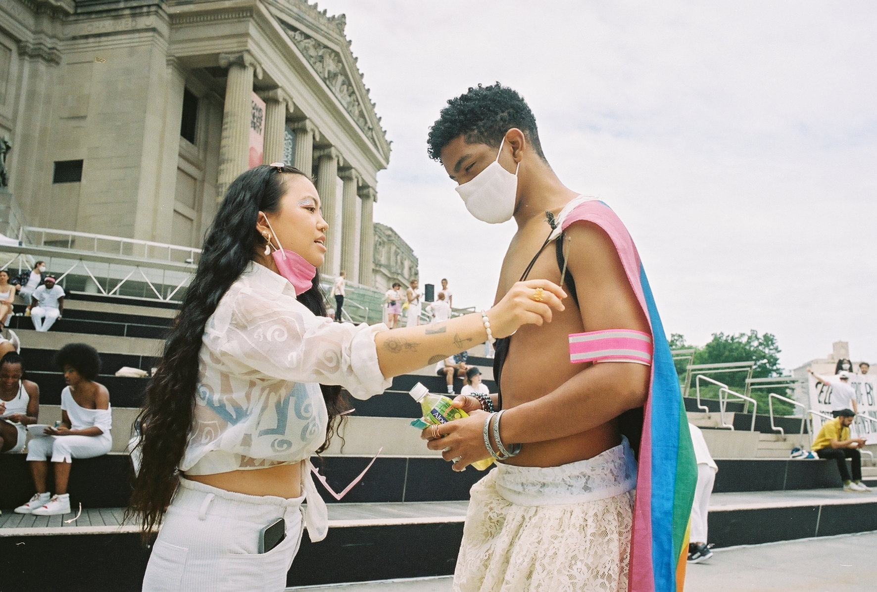 Jezz Chung helping someone with their trans rights flag.