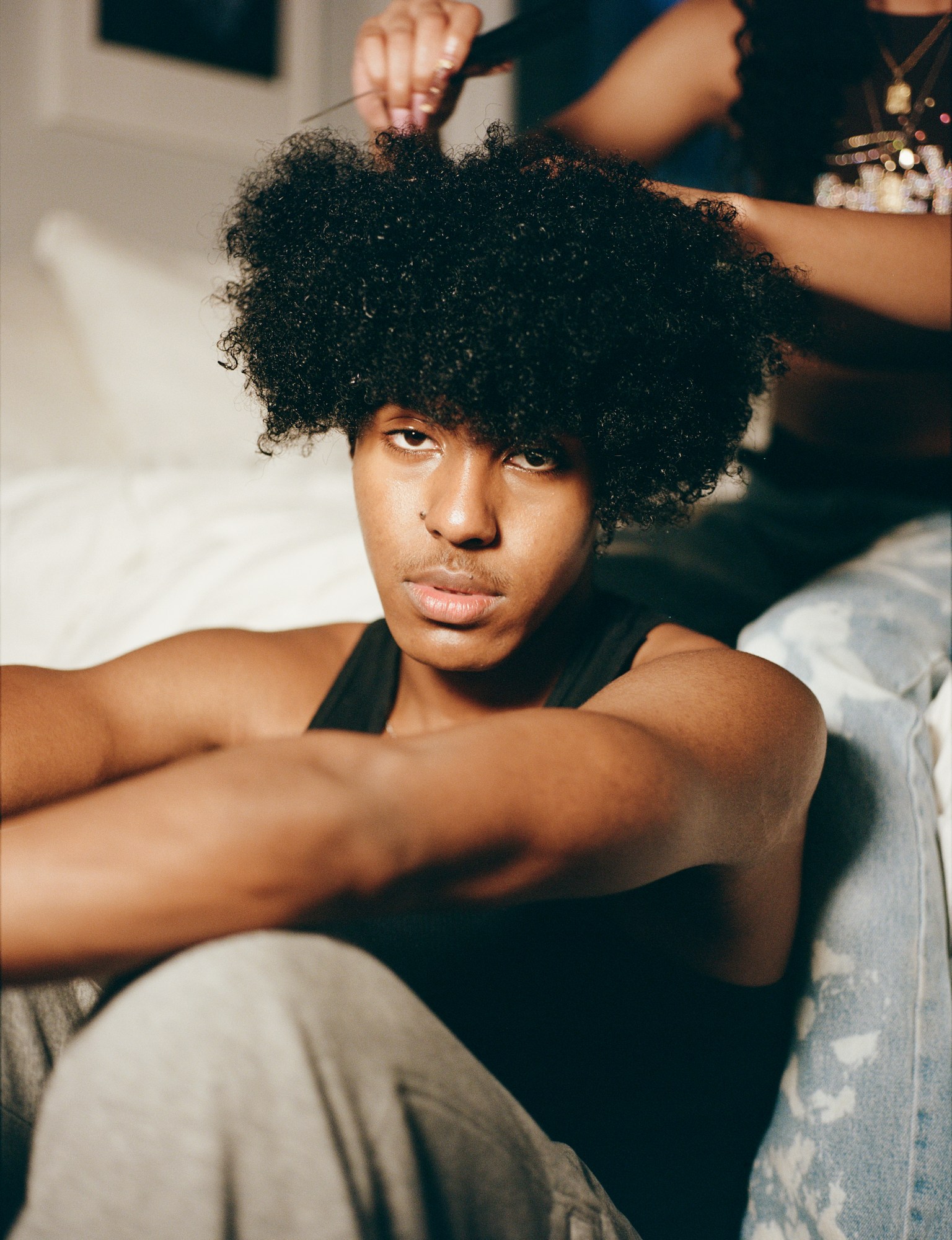 a boy getting his hair combed by kadar small