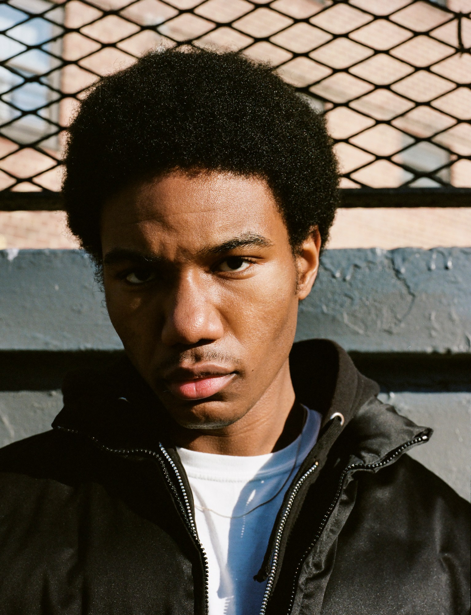 a close up portrait of a man outside in nyc by kadar small