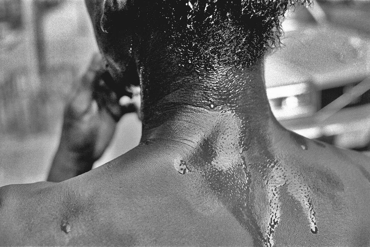 a man's neck and back covered in sweat