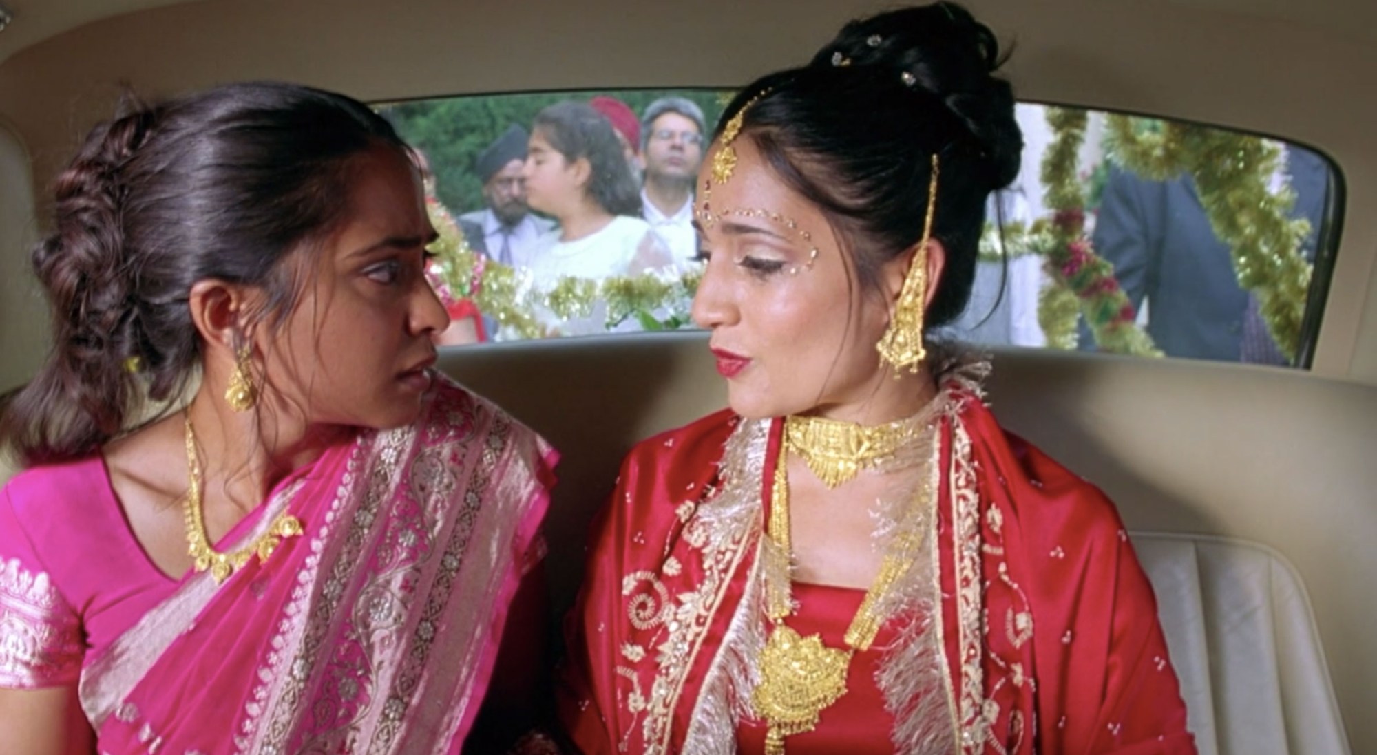 two young indian women wearing saris and gold jewellery, from the movie Bend It Like Beckham