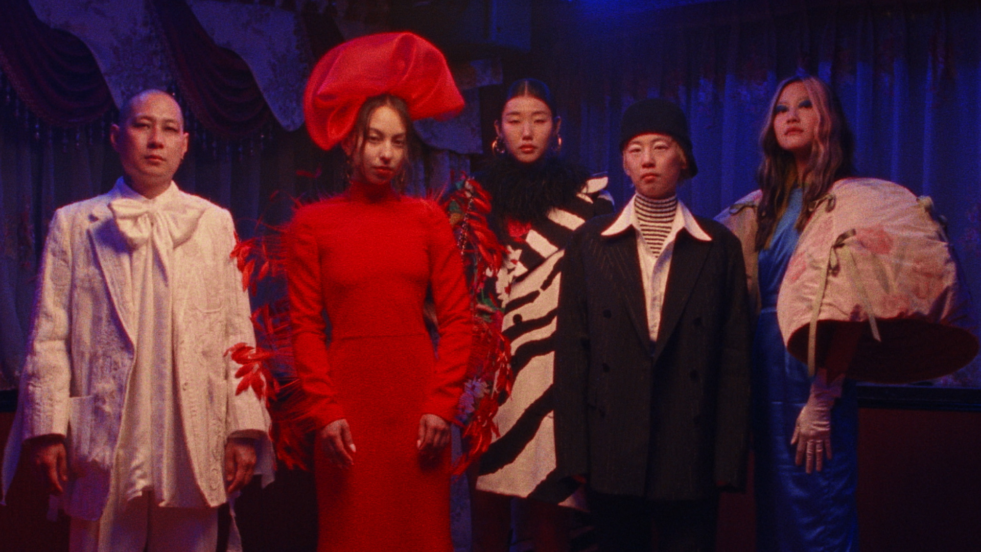 a group of asian american creatives dressed up and posing in a restaurant