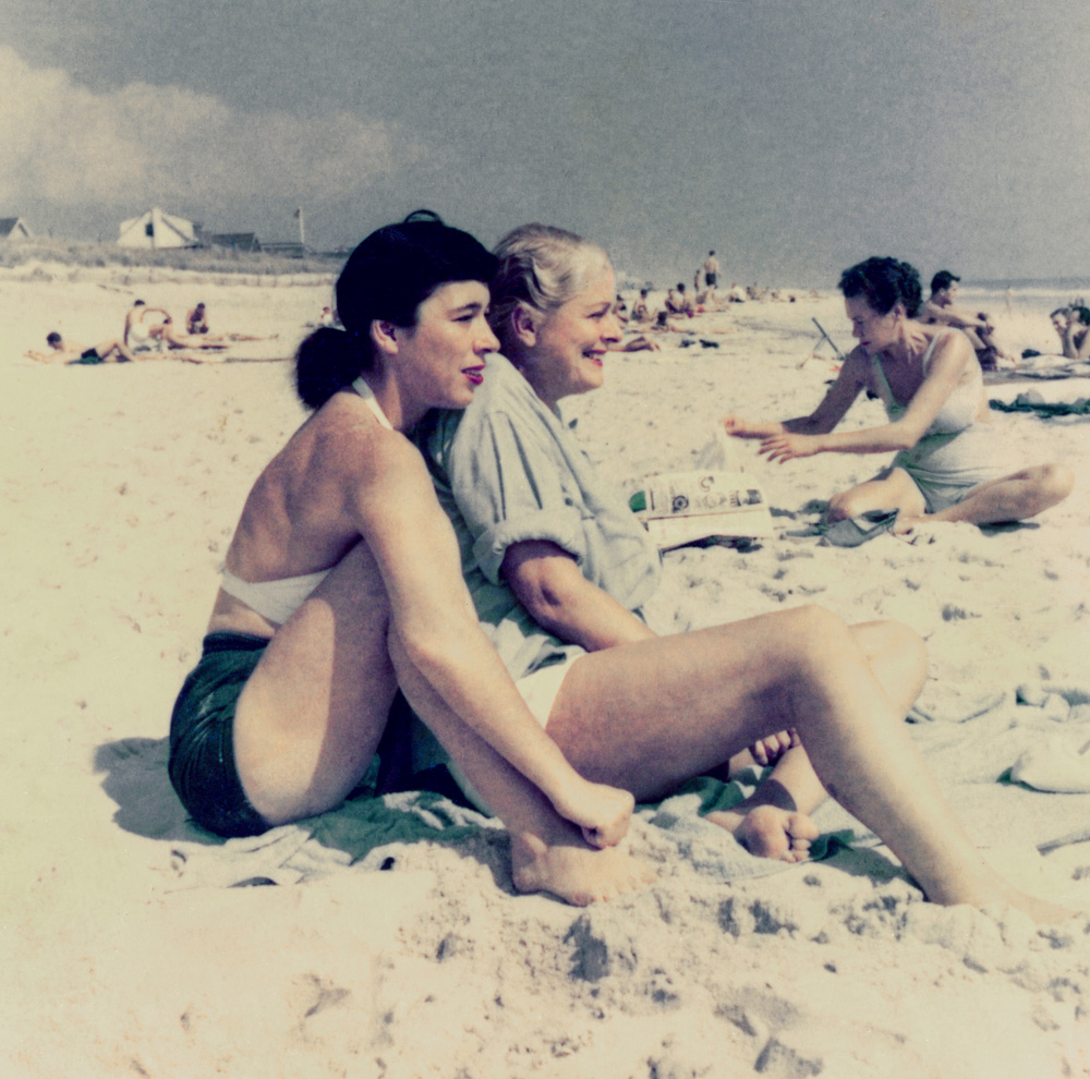 two women embracing on the beach in cherry grove, fire island