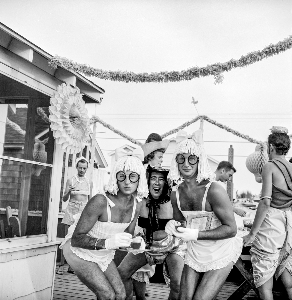 three partygoers wearing diapers and mop wigs in 1950s fire island