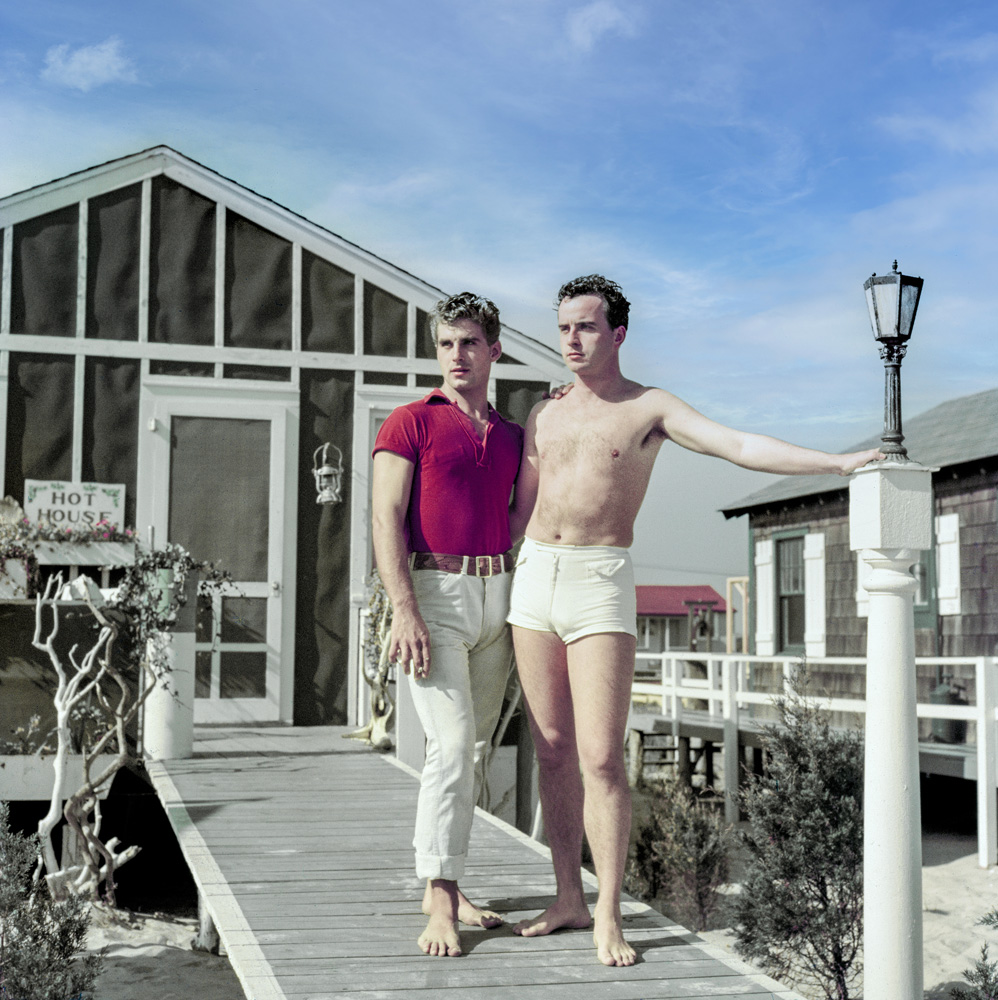 two men posing outside the hot house fire island