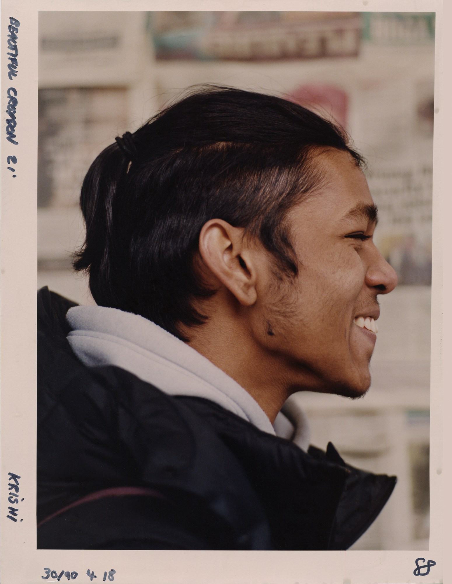 a young man's side profile as he laughs