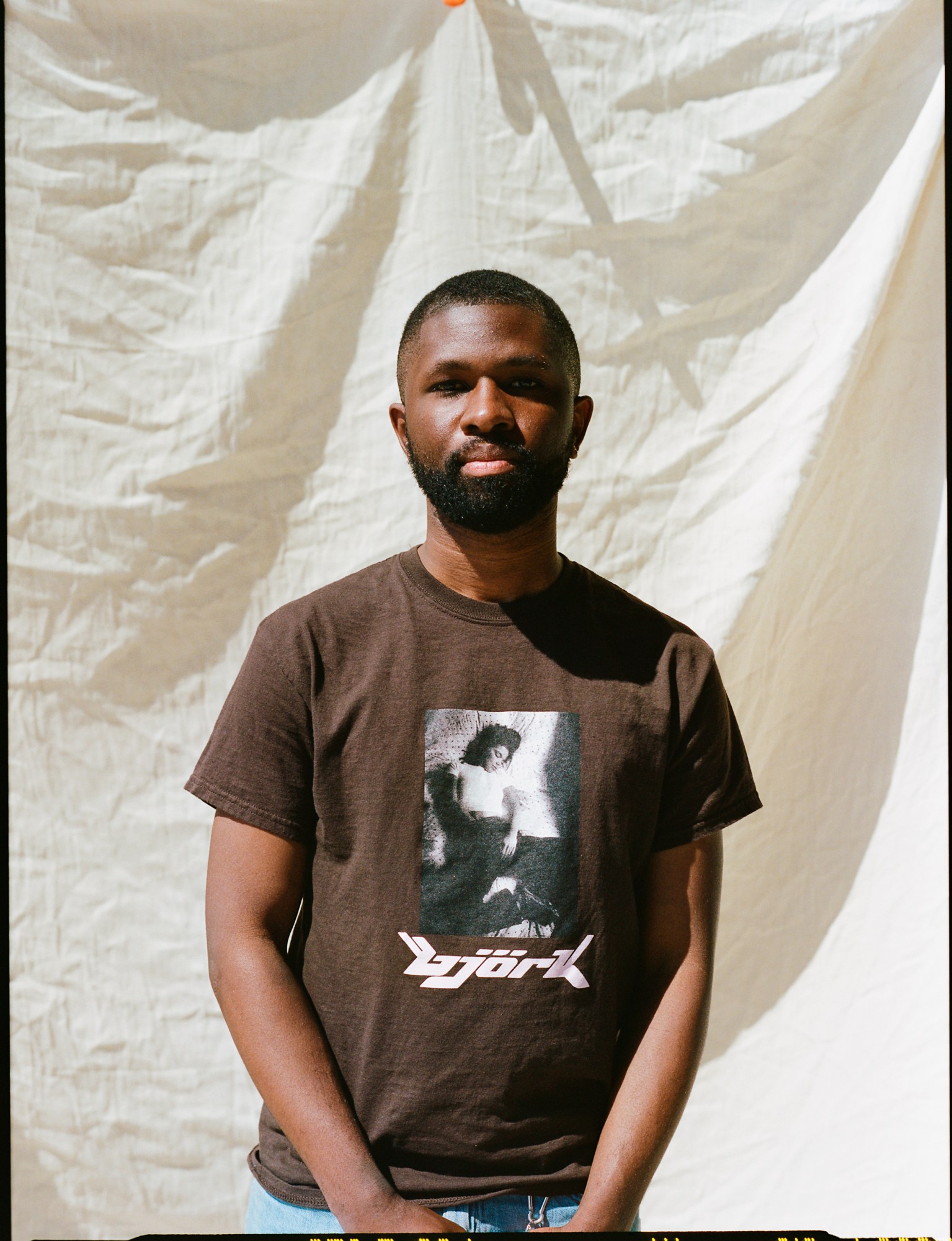 a portrait of a skateboarder wearing a bjork t-shirt