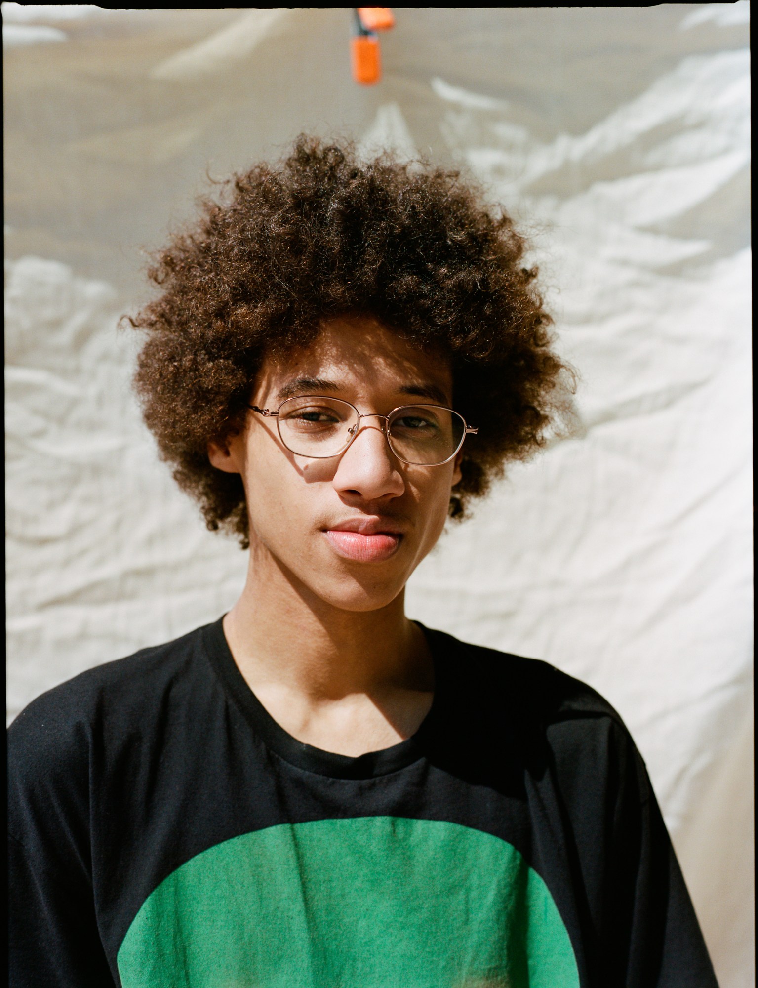 a portrait of a skateboarder wearing glasses