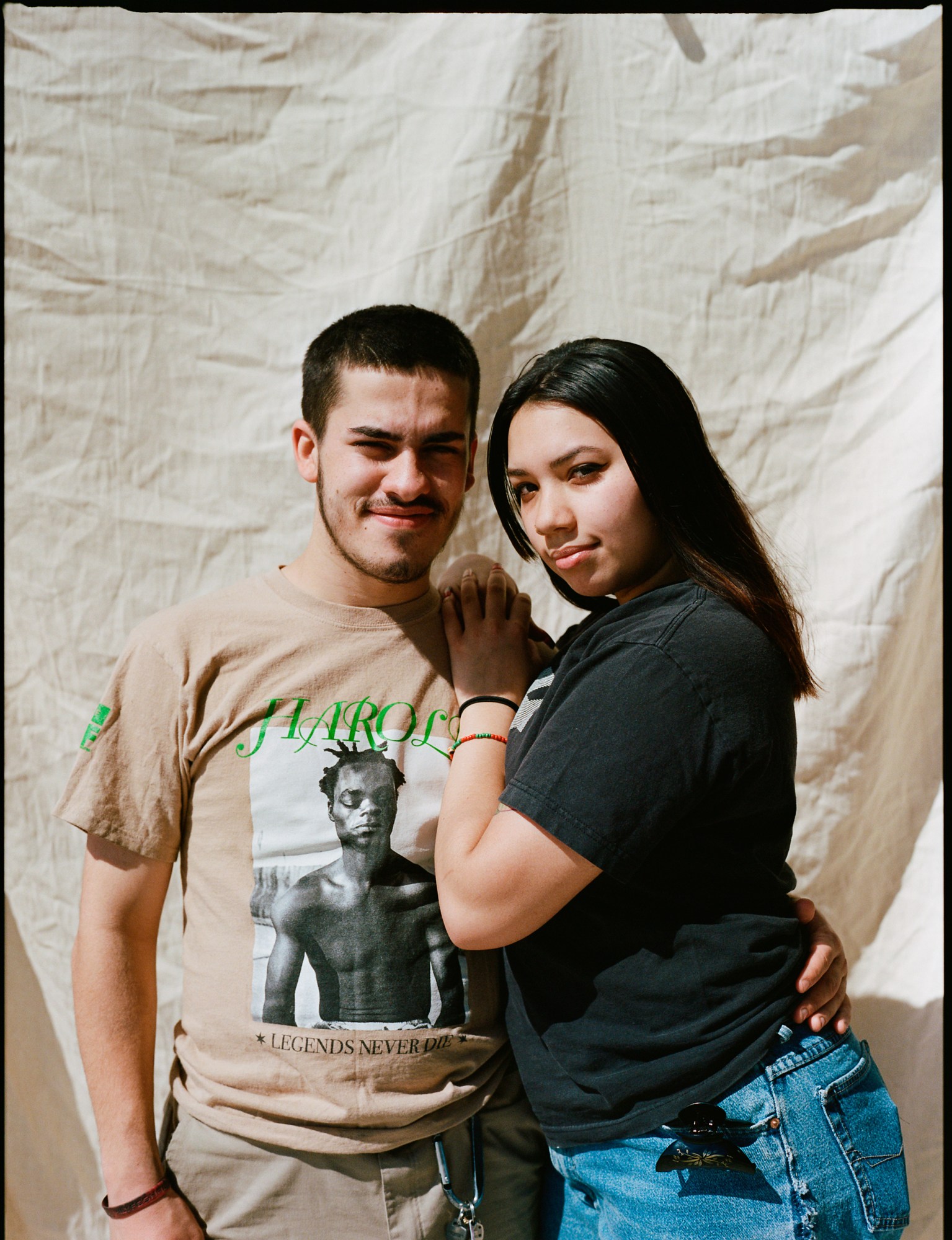 a portrait of a man and a woman, the man is wearing a harold hunter t-shirt