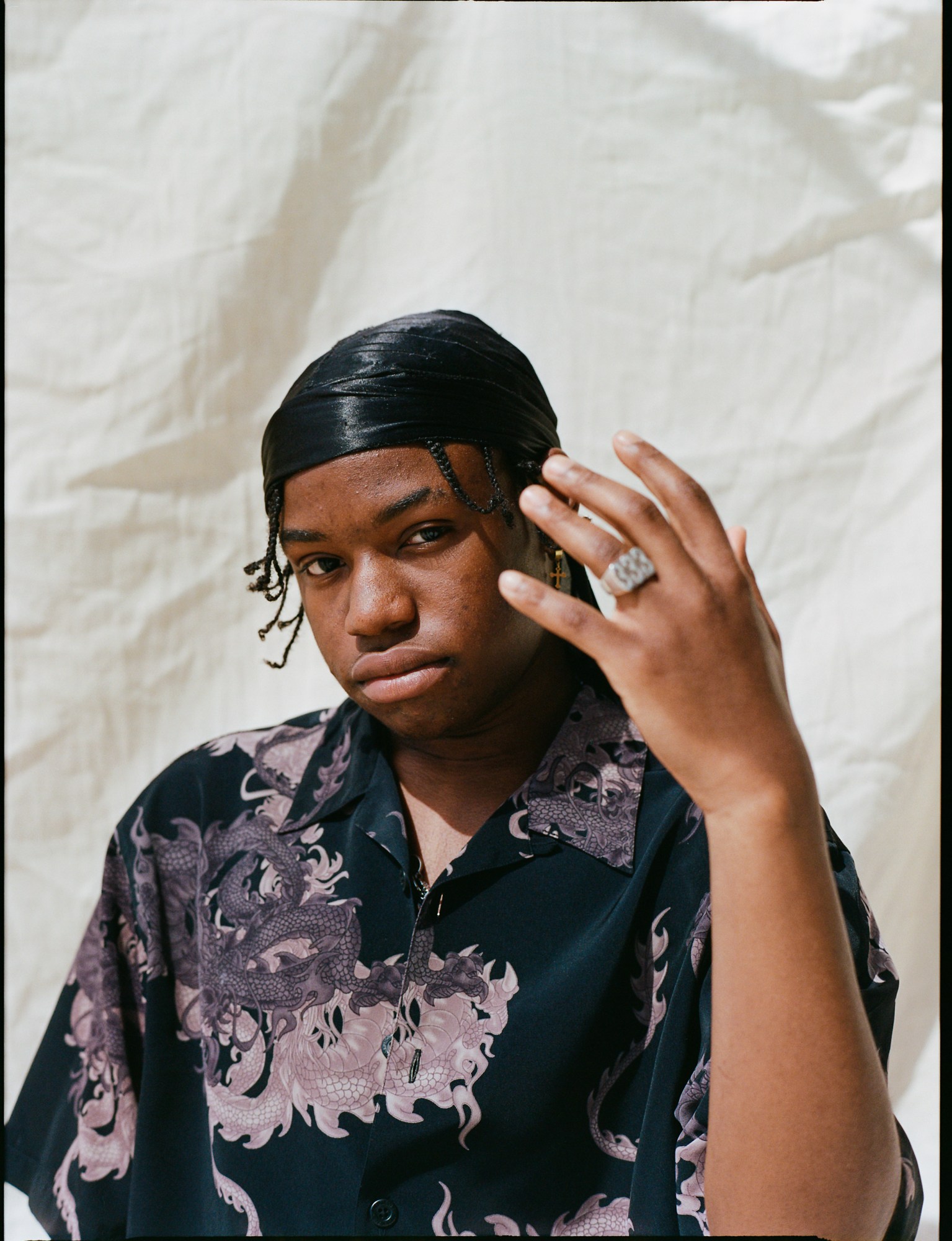 a portrait of a skateboarder wearing a durag