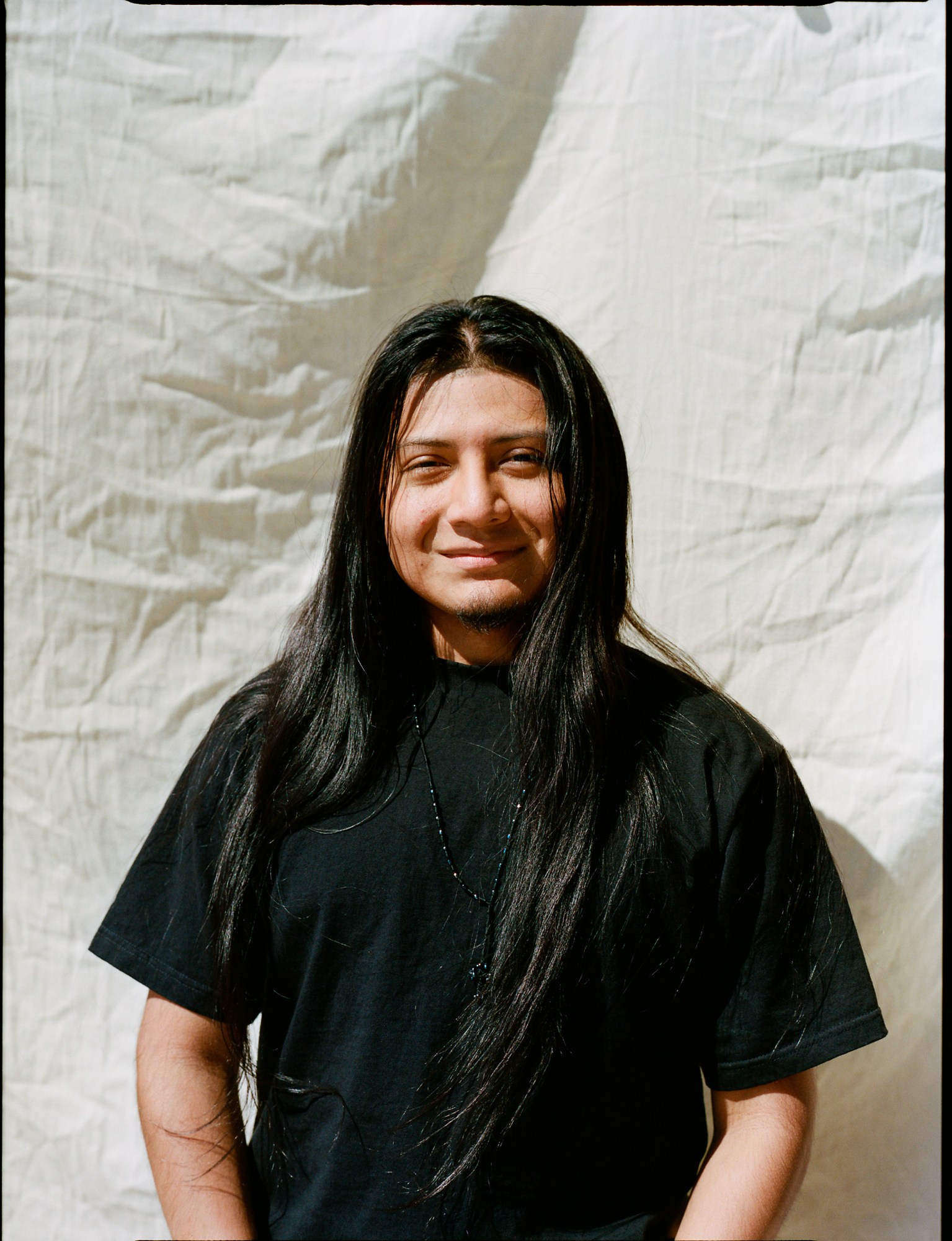 a portrait of a skateboarder with long hair