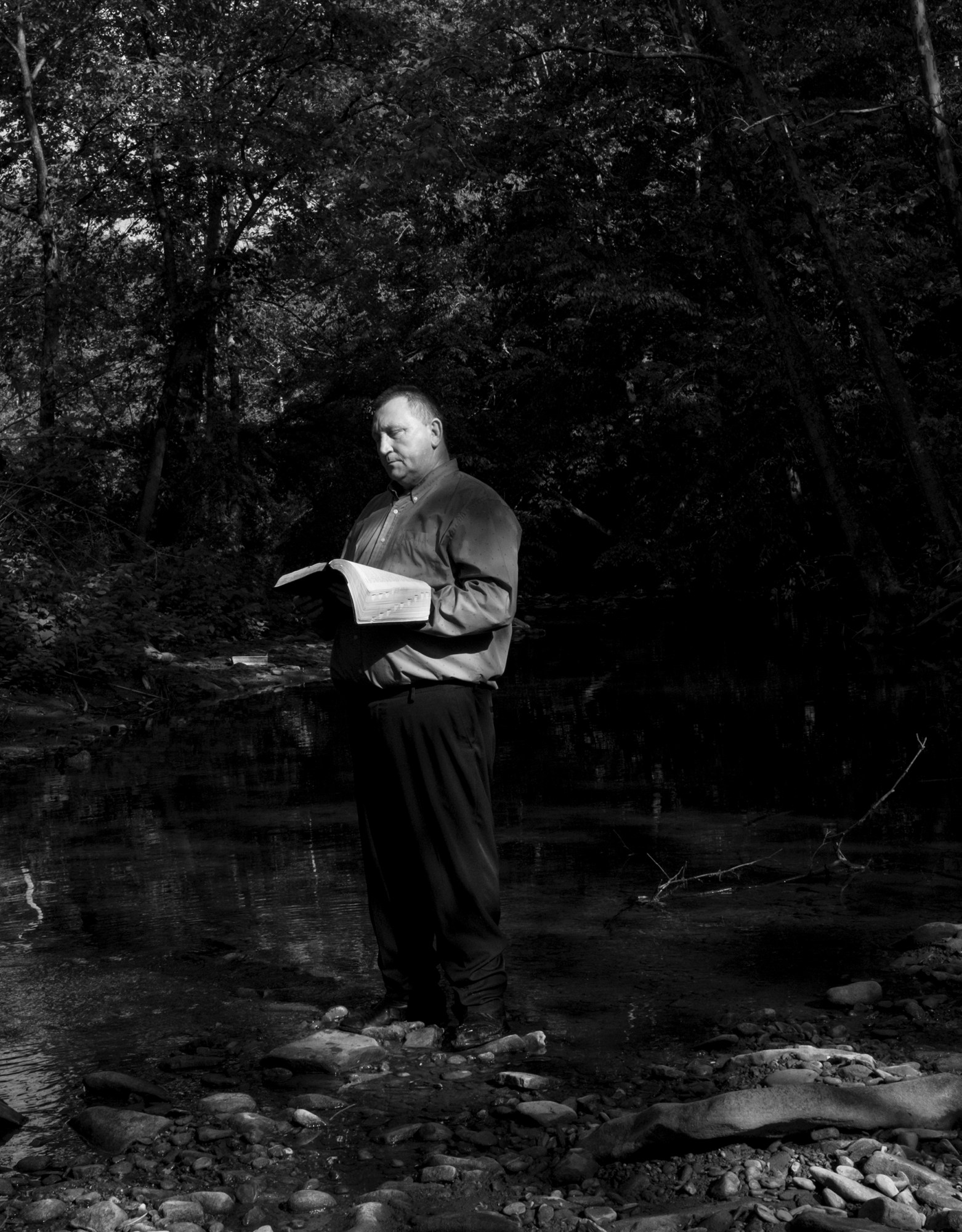 a pastor holding a bible and reading