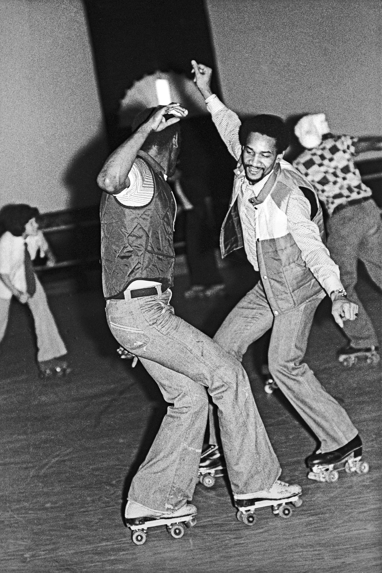 two men dancing and roller skating