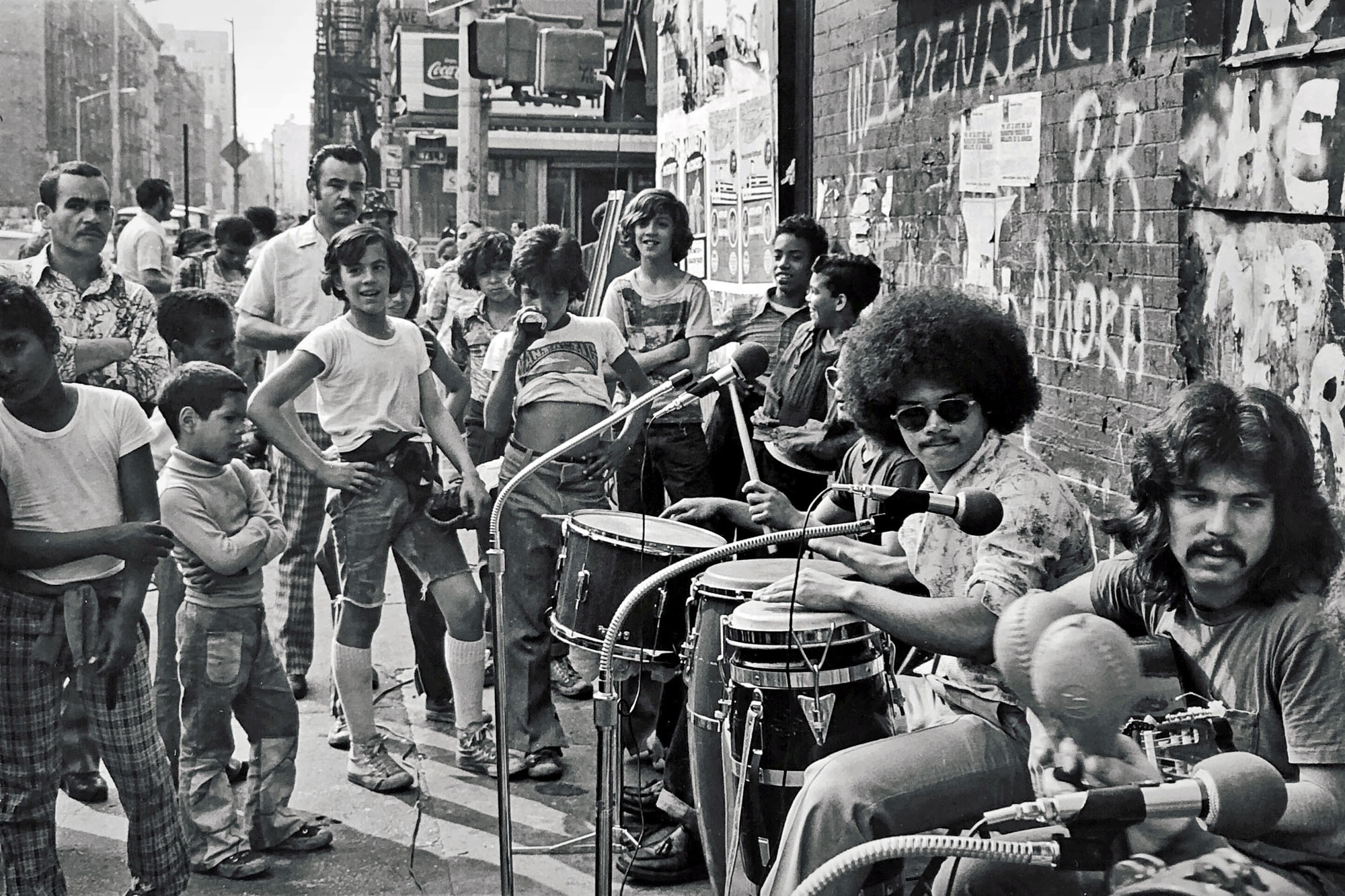 a salsa band perform to a group of people on the street