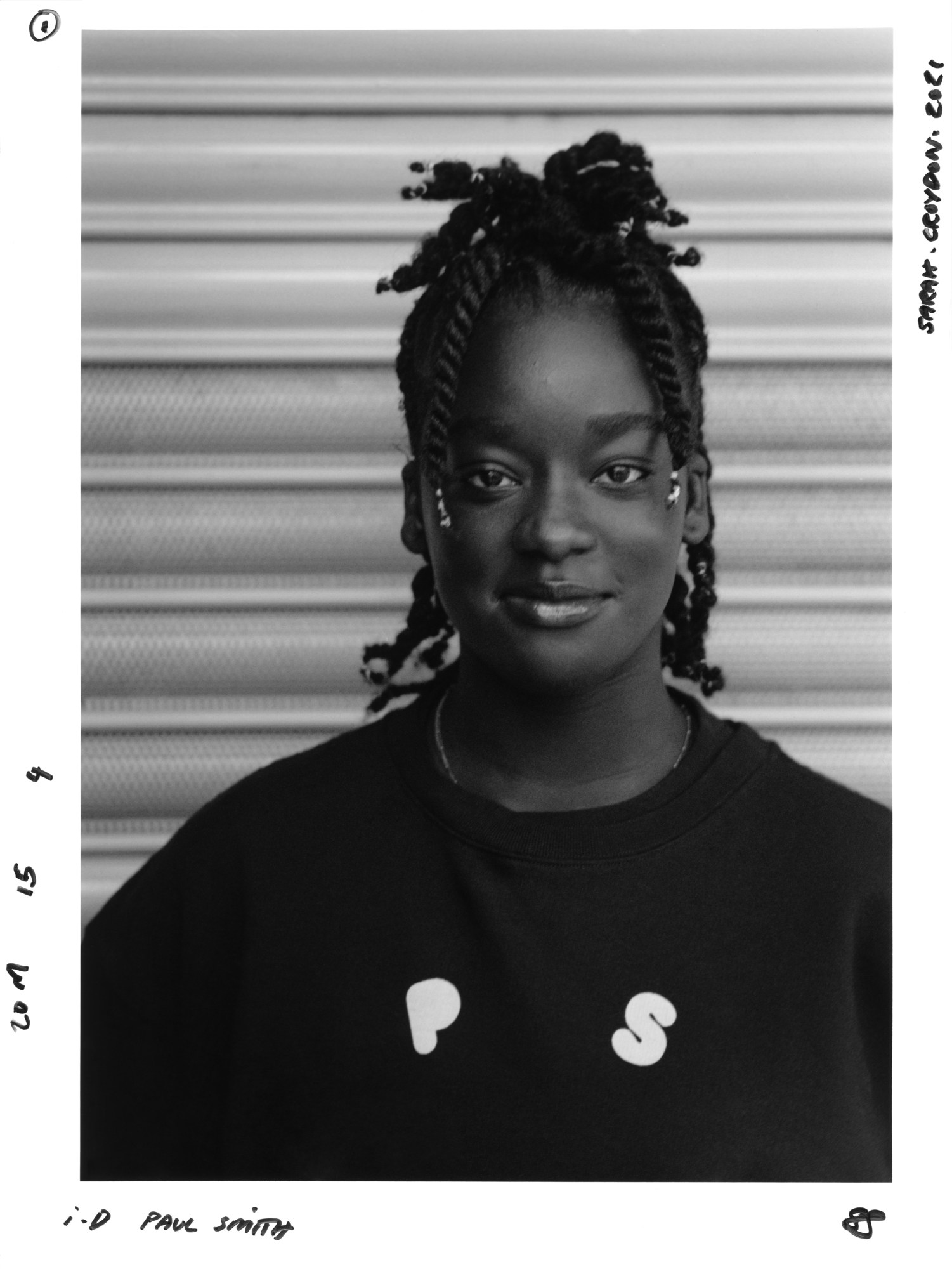 a young woman wearing ps by paul smith looks into the camera