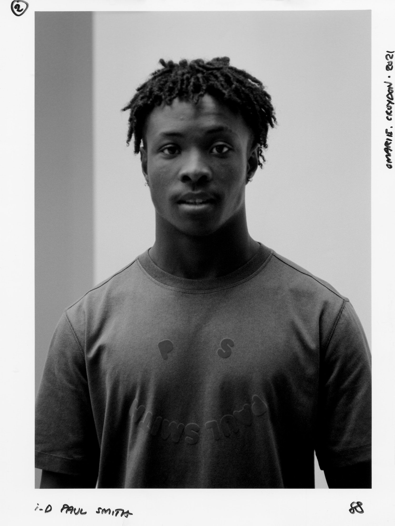 a young man wearing ps by paul smith looks into the camera