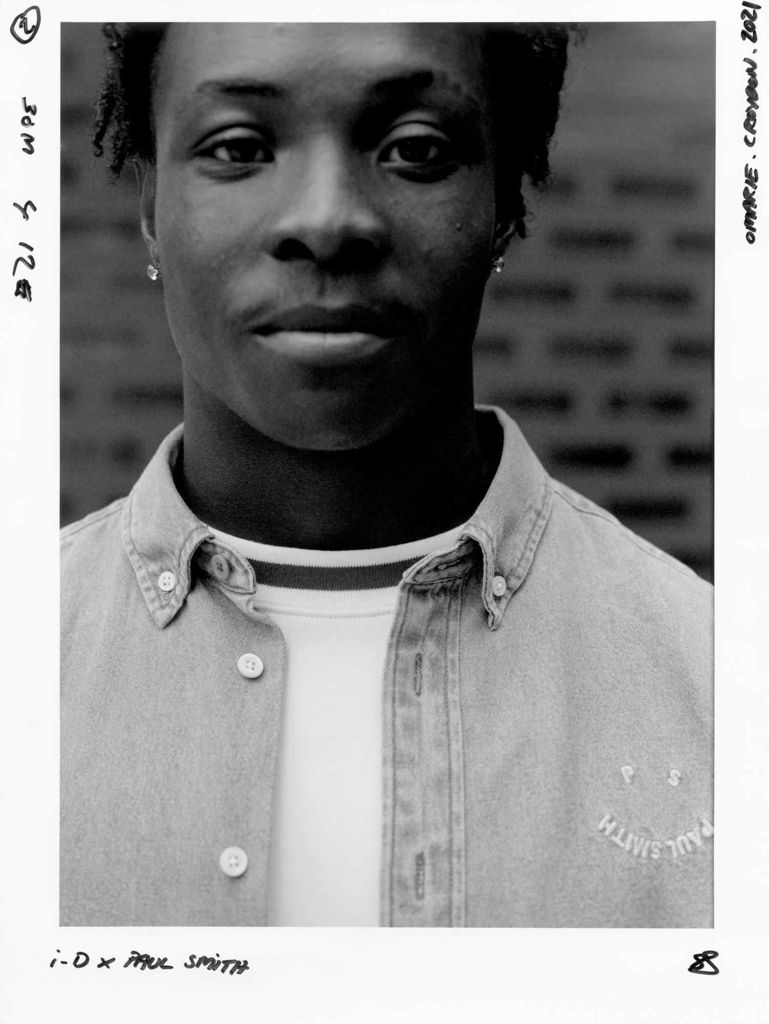 a young man wearing ps by paul smith looks into the camera