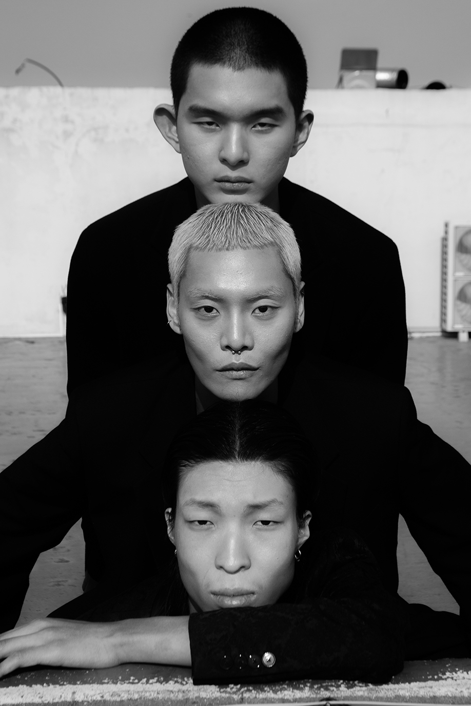 three men's heads arranged on top of each other