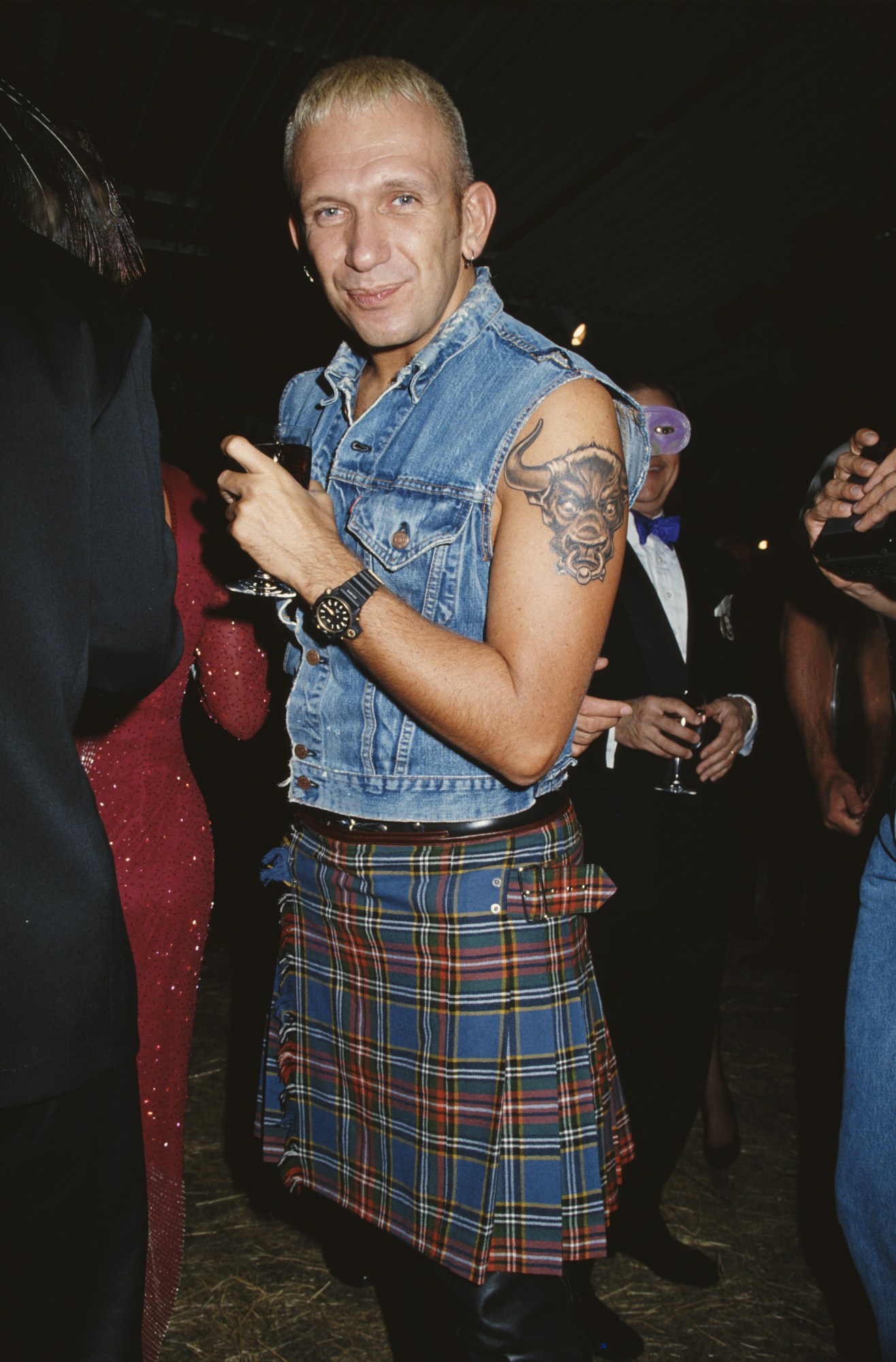 Jean-Paul Gaultier wearing a denim vest and tartan kilt